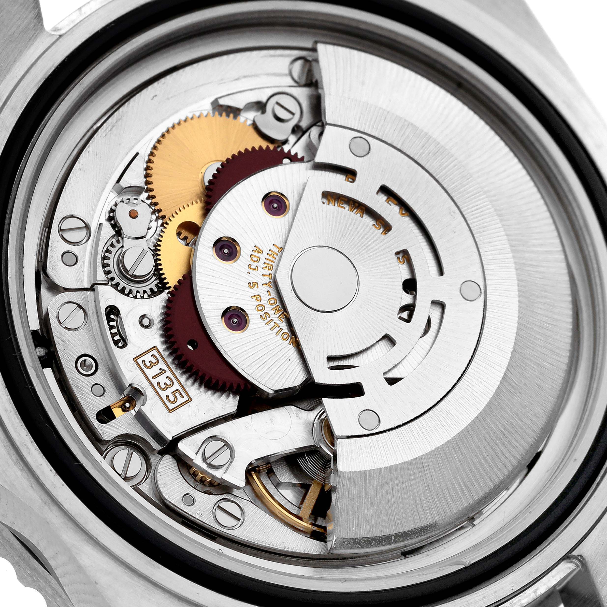 The image shows the movement and intricate inner workings of a Rolex Submariner 16610 Men
s Stainless Steel Black Dial 16610 Men
s Stainless Steel Black Dial watch, highlighting its gears and rotor.