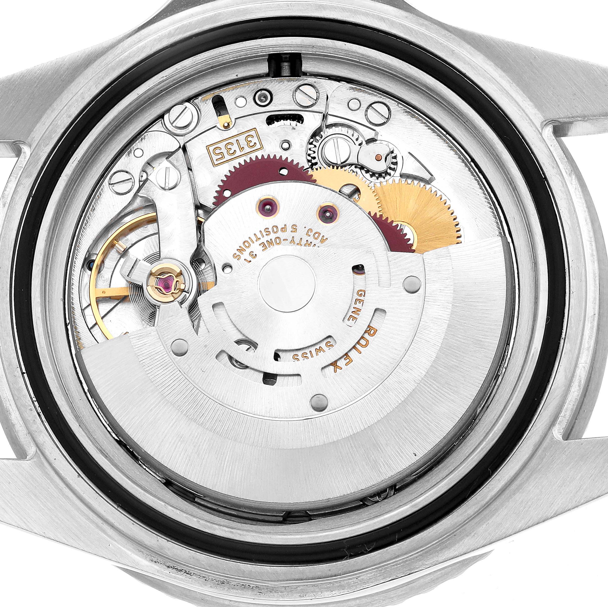 The image shows the exposed movement of a Rolex Submariner 16610 Men's Stainless Steel Black Dial, viewed from the back, highlighting the intricate internal mechanism.