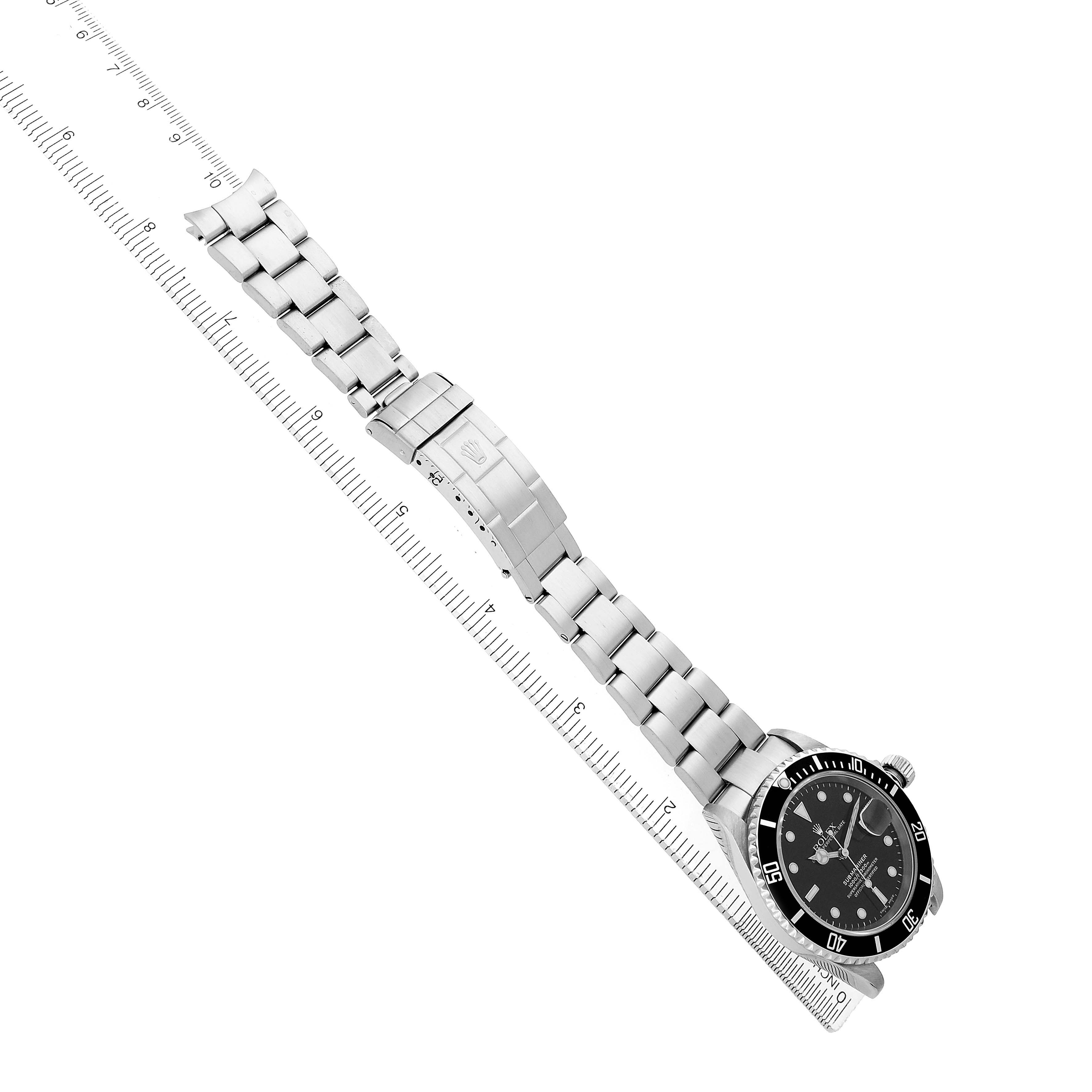 The Rolex Submariner 16610 Men's Stainless Steel Black Dial watch is shown from an overhead angle, displaying its bracelet, clasp, bezel, and dial.