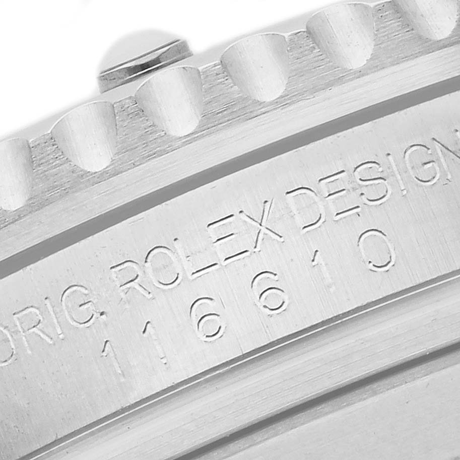 The image shows a close-up of the engraved edge and serial number of a Rolex Submariner 116610LV Men's Stainless Steel Green Dial watch bezel.