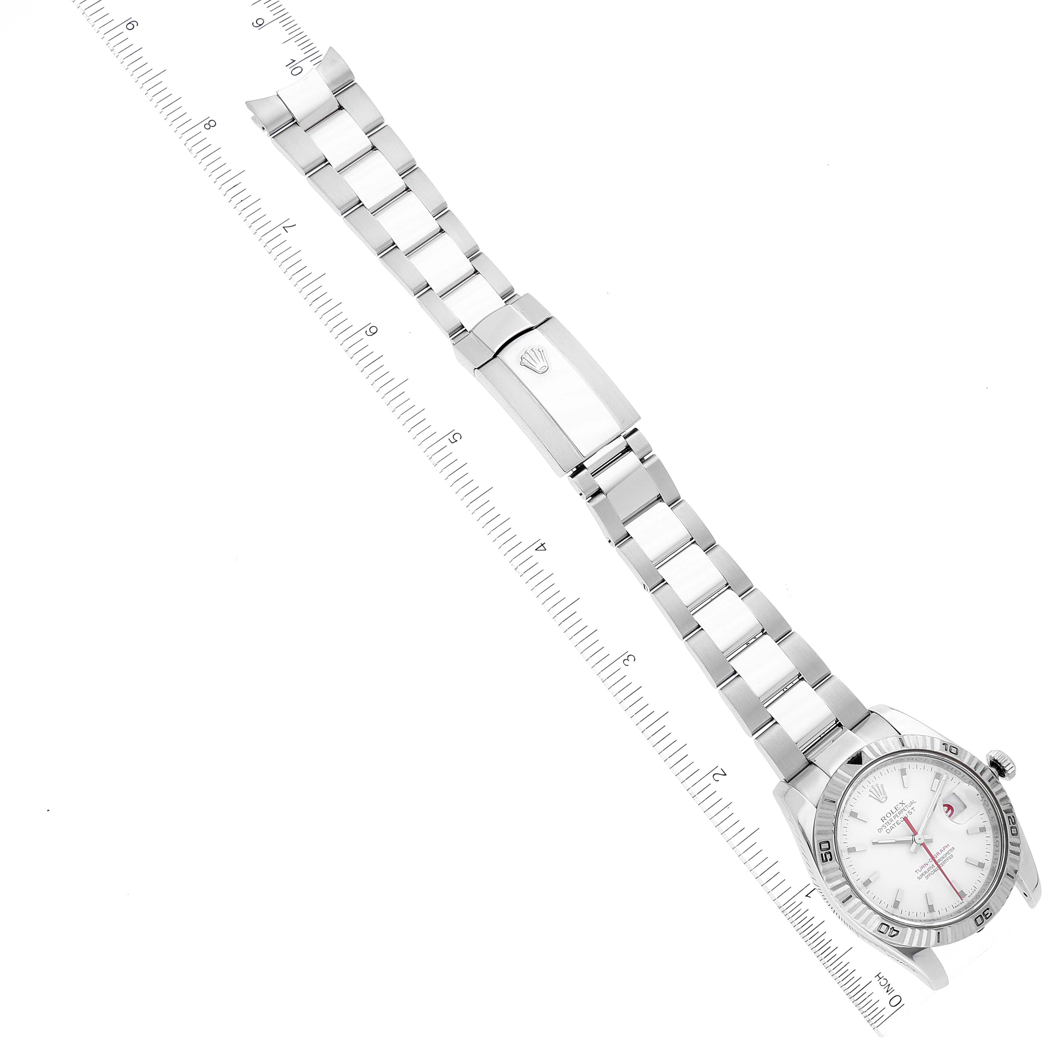 The Rolex Turn-o-Graph 116264 Men
s Stainless Steel White Dial 116264 Men
s Stainless Steel White Dial watch is shown at a top-down angle, featuring the full bracelet and part of the face with measuring rulers beside it.