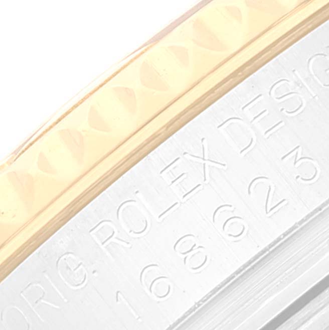 The close-up image shows the engraved bezel and part of the case of a Rolex Yacht-Master 168623 Women's Steel and Gold (two tone) White Dial 168623 Women's Steel and Gold (two tone) White Dial watch.