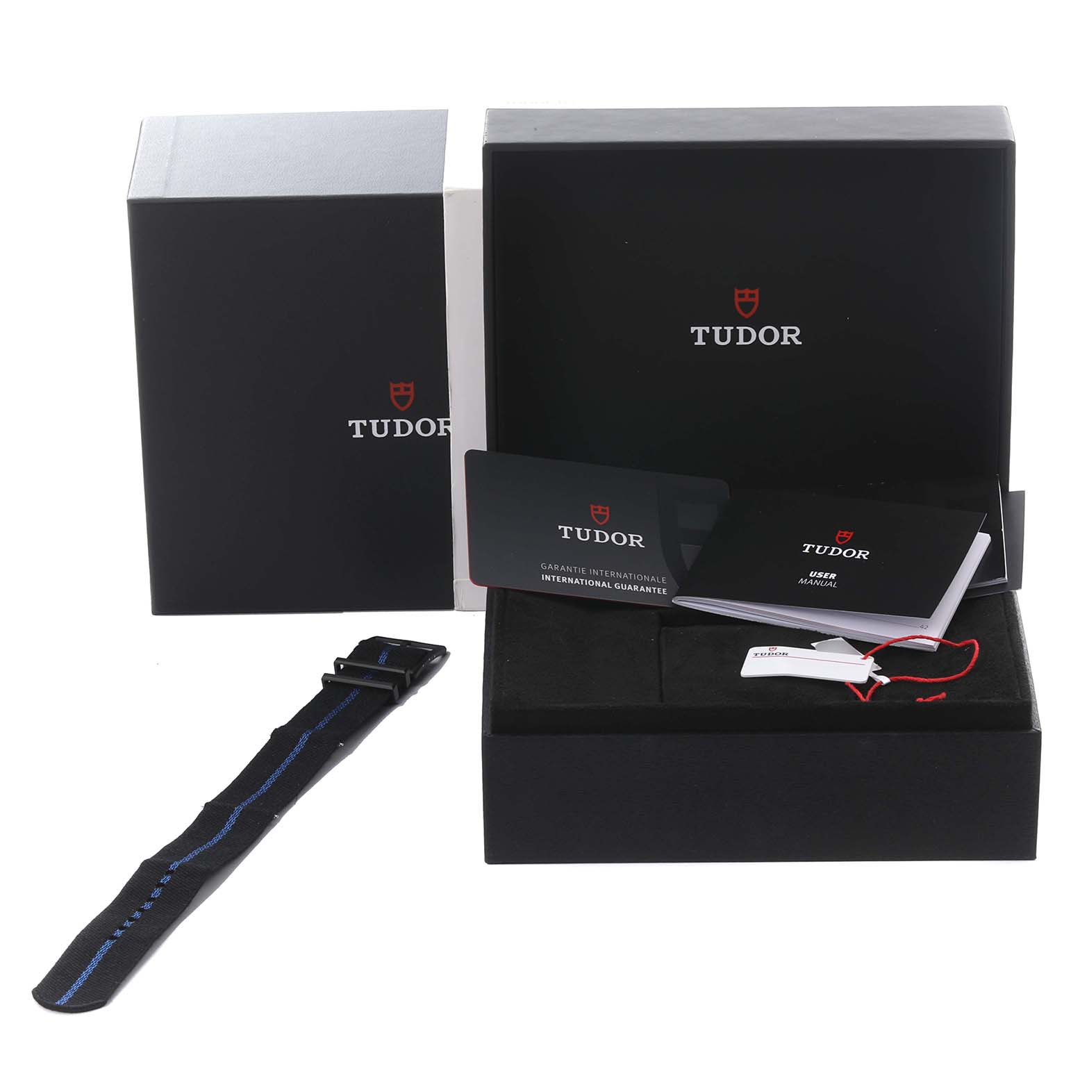 The image shows the Tudor Heritage Black Bay 79210CNU Men's Ceramic Blue Dial 79210CNU Men's Ceramic Blue Dial watch box, manuals, guarantee cards, and an extra strap from a front angle.