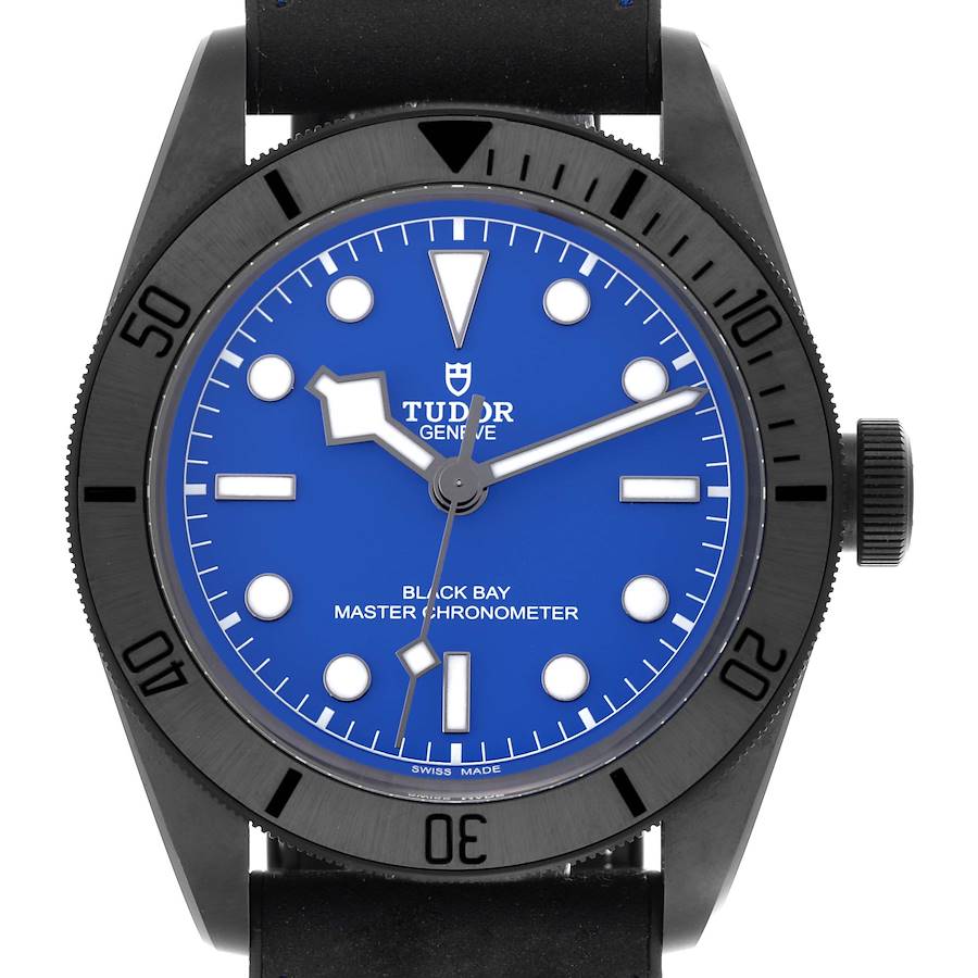 The Tudor Heritage Black Bay watch is shown from a front angle, displaying its blue dial, bezel, and crown.