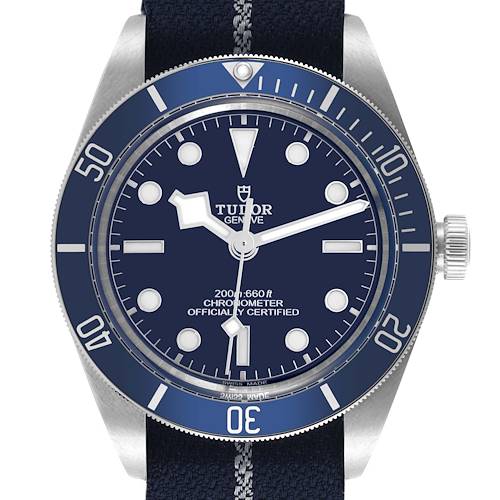 The Tudor Heritage Black Bay watch is shown from a frontal angle, displaying its face, bezel, and crown.
