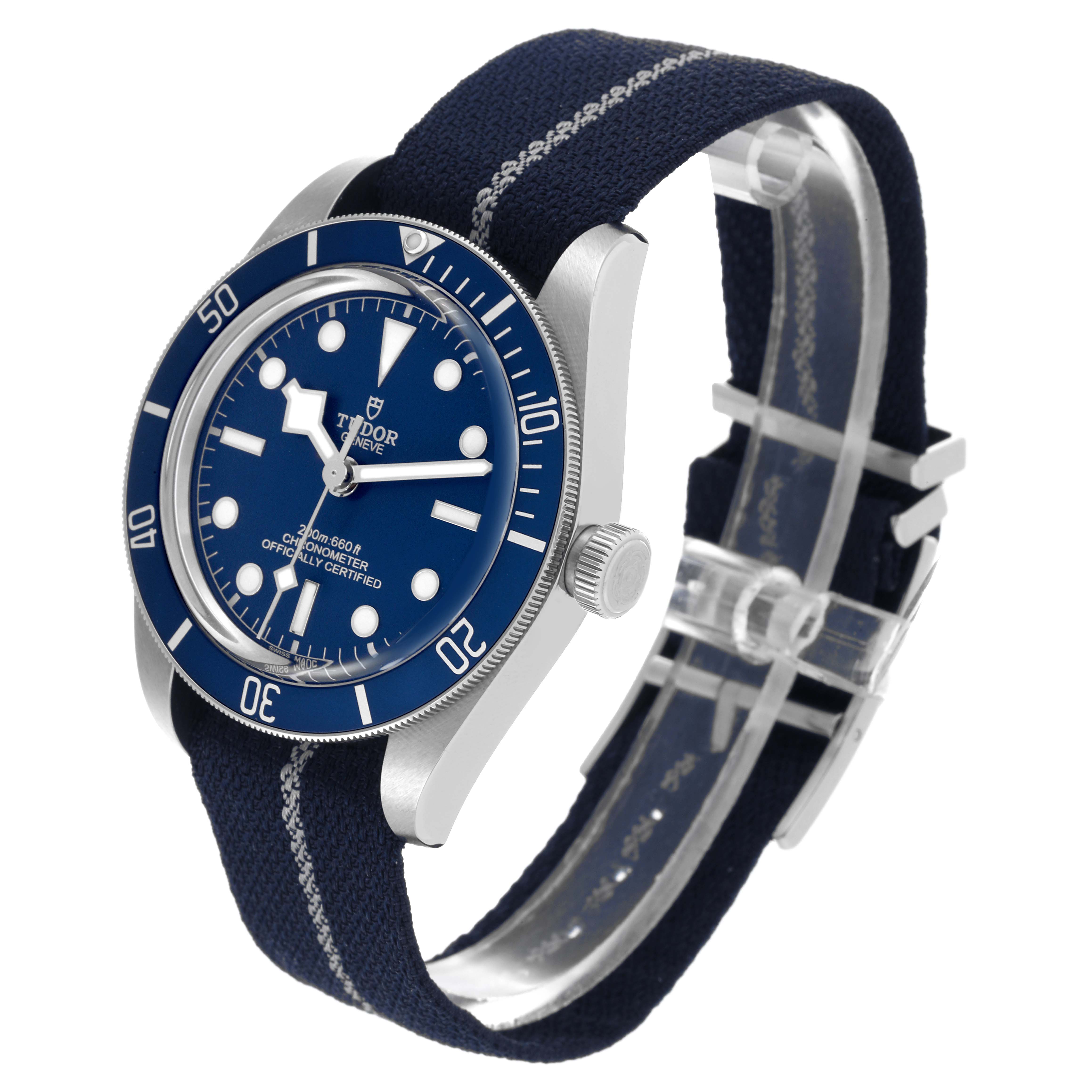 The Tudor Heritage Black Bay 79030 Men's Stainless Steel Blue Dial 79030 Men's Stainless Steel Blue Dial watch is shown at an angle revealing the face, bezel, crown, and fabric strap.