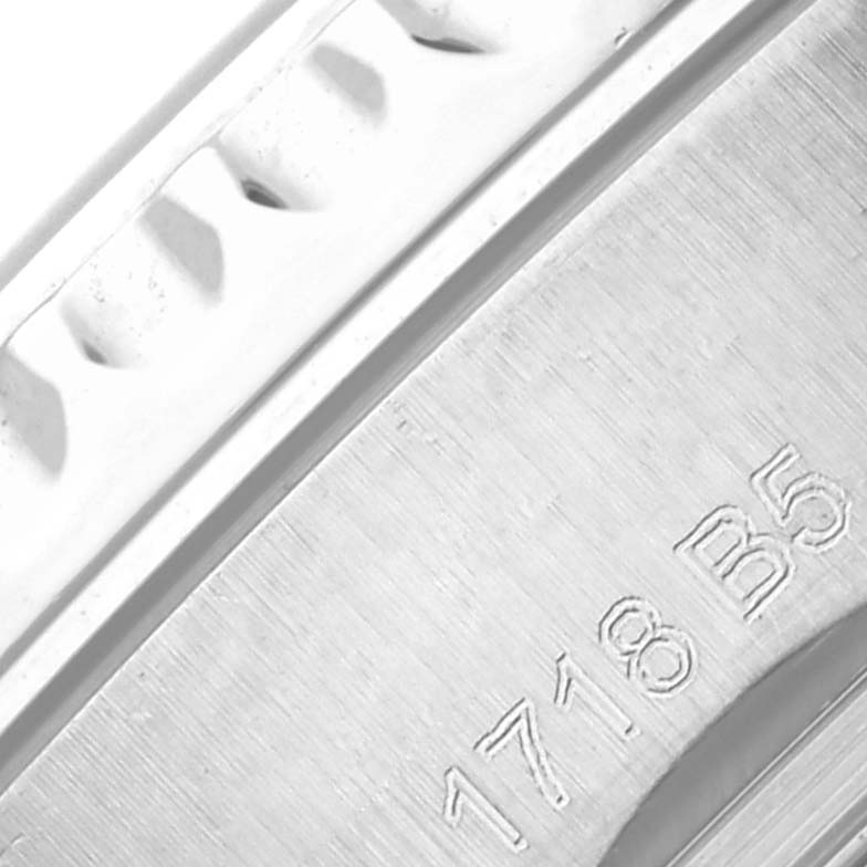 The image shows a close-up of the side of a Breitling Navitimer AB0117 Men's Stainless Steel Blue Dial AB0117 Men's Stainless Steel Blue Dial watch, focusing on the bezel and engraved details.