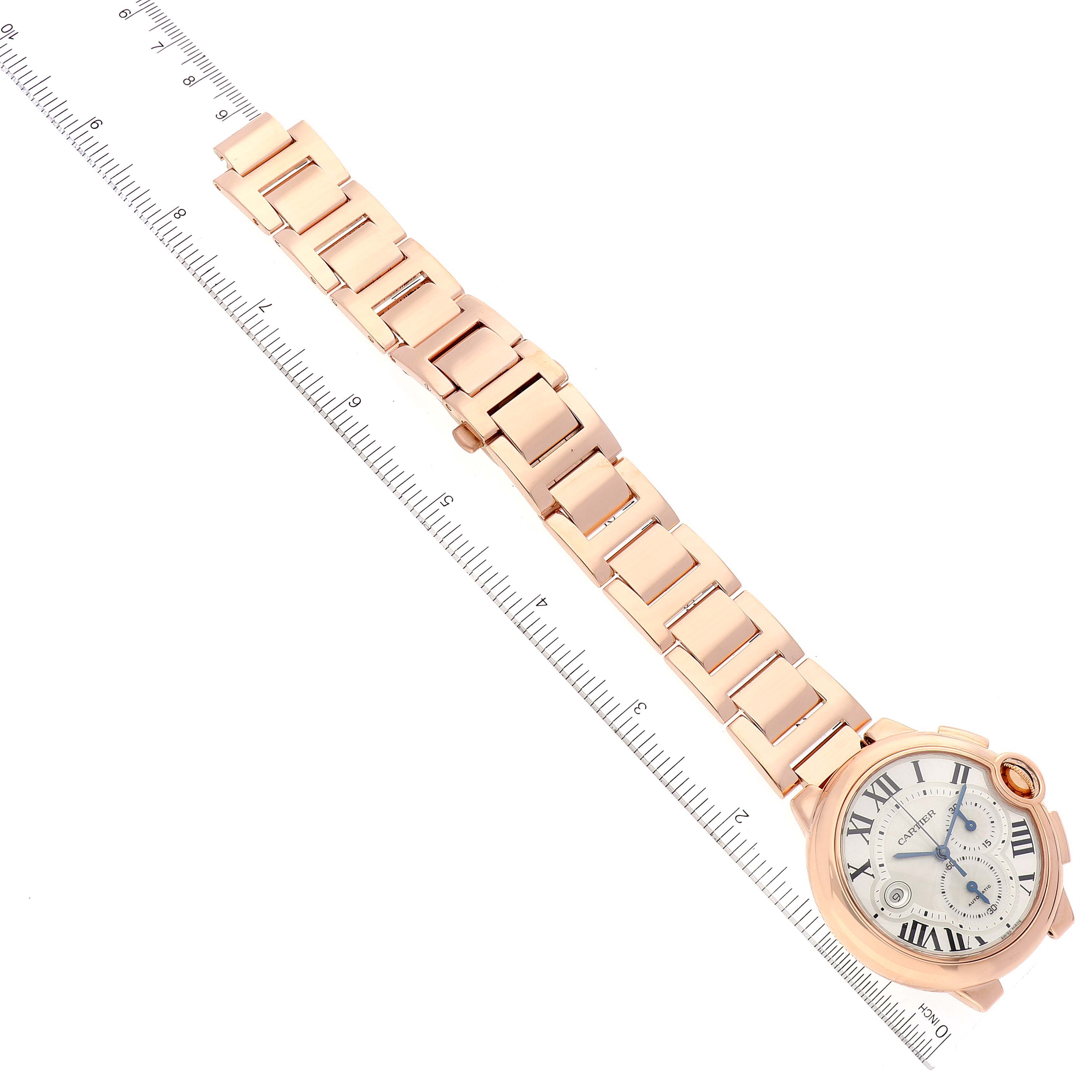 The image shows the Cartier Ballon Bleu W6920008 Men
s Rose Gold Silver Dial W6920008 Men
s Rose Gold Silver Dial watch laid flat at an angle, with both the face and an extended bracelet visible next to a ruler.