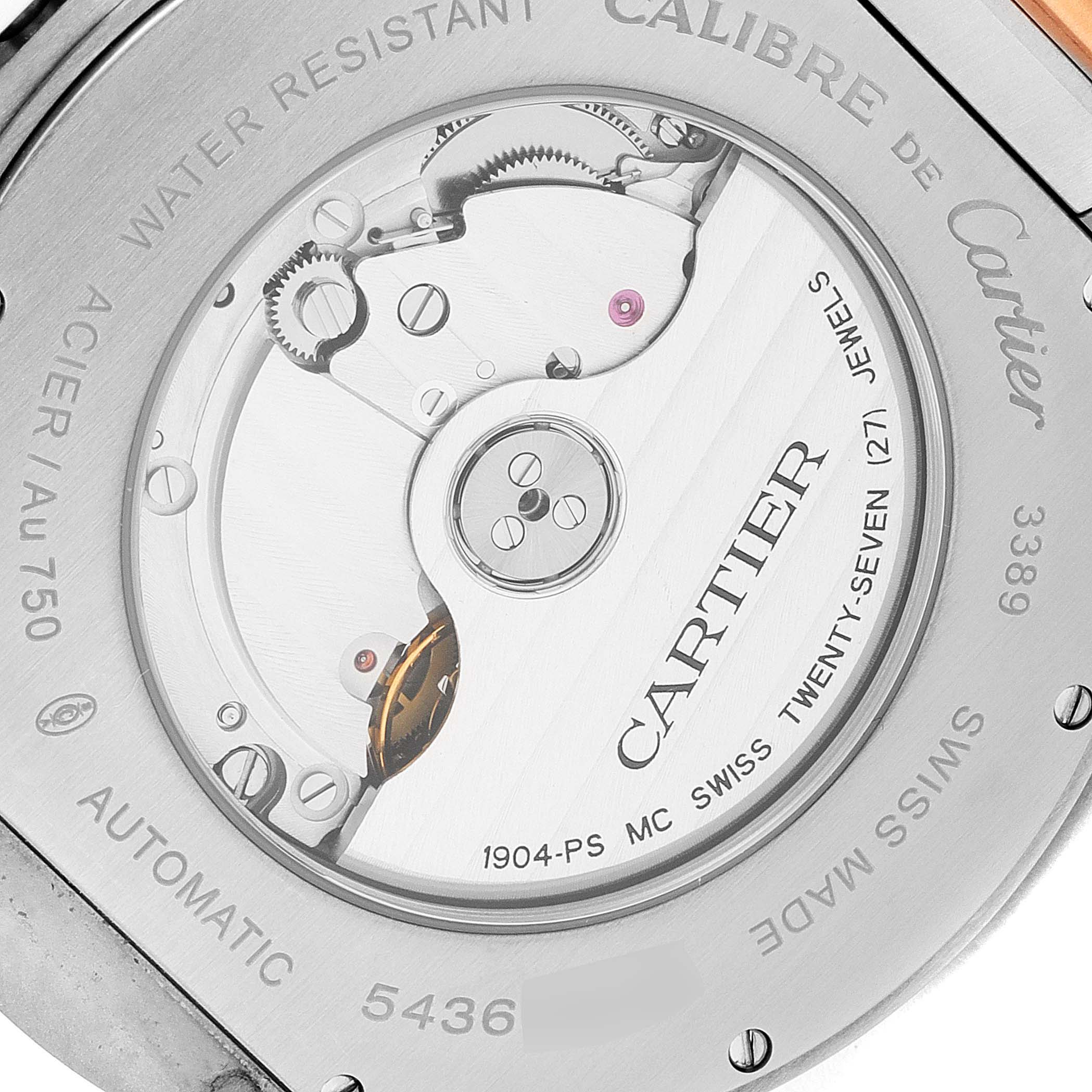 The image shows the case back and inner mechanism of a Calibre de Cartier watch by Cartier.