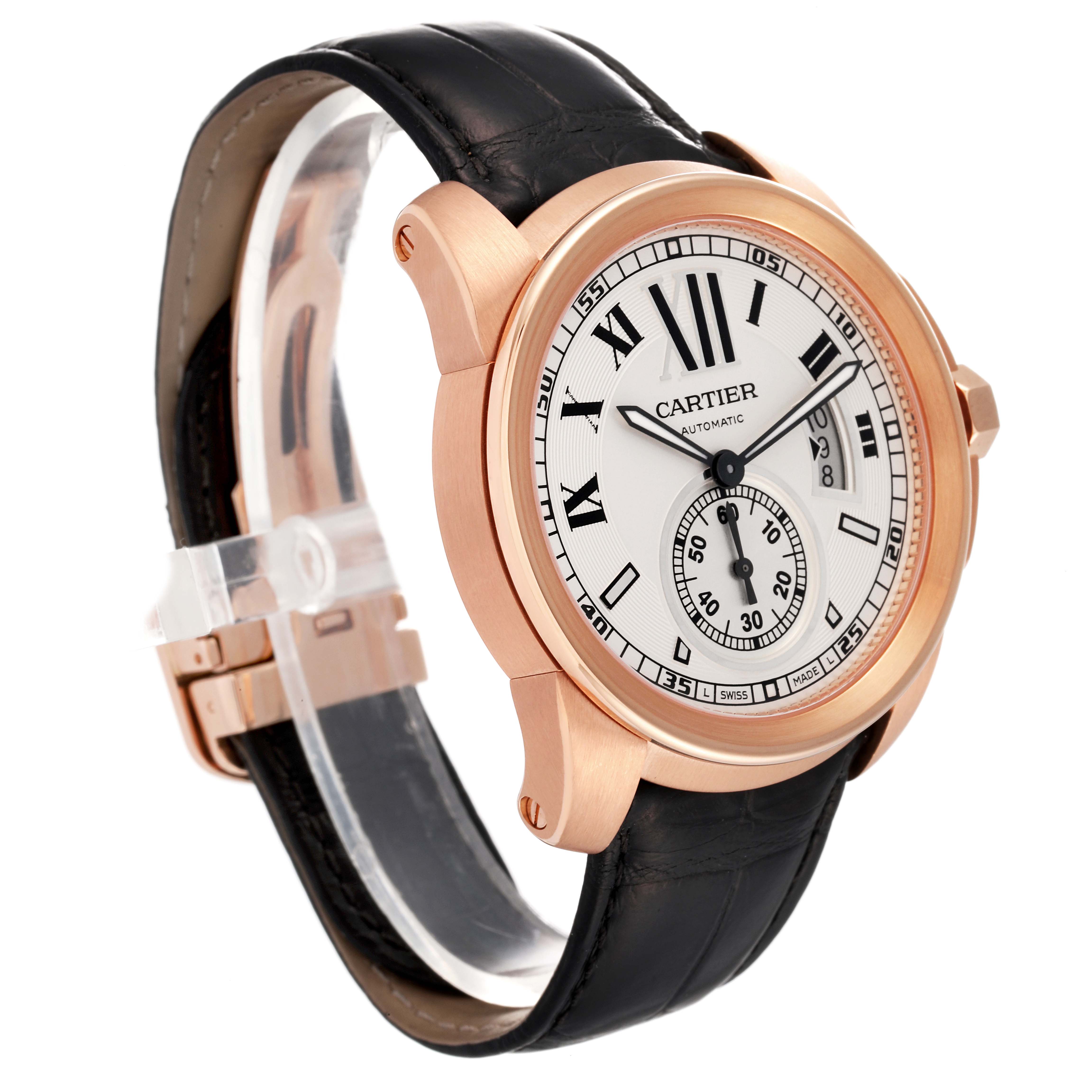 The image shows a Calibre de Cartier watch by Cartier at an oblique angle, highlighting its face, case, and black leather strap.