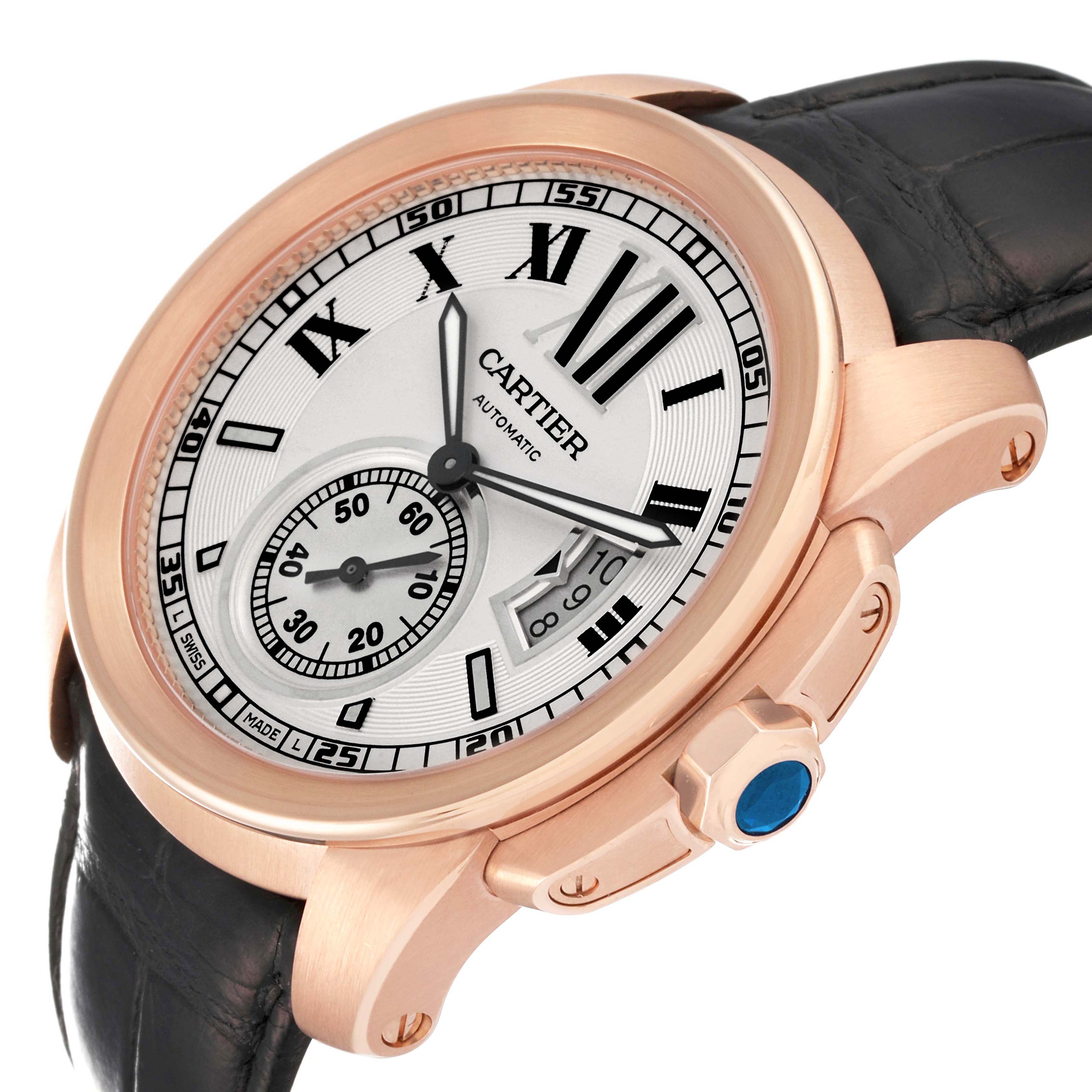 The Calibre de Cartier watch is shown at a slight angle, highlighting the face, bezel, and part of the strap.