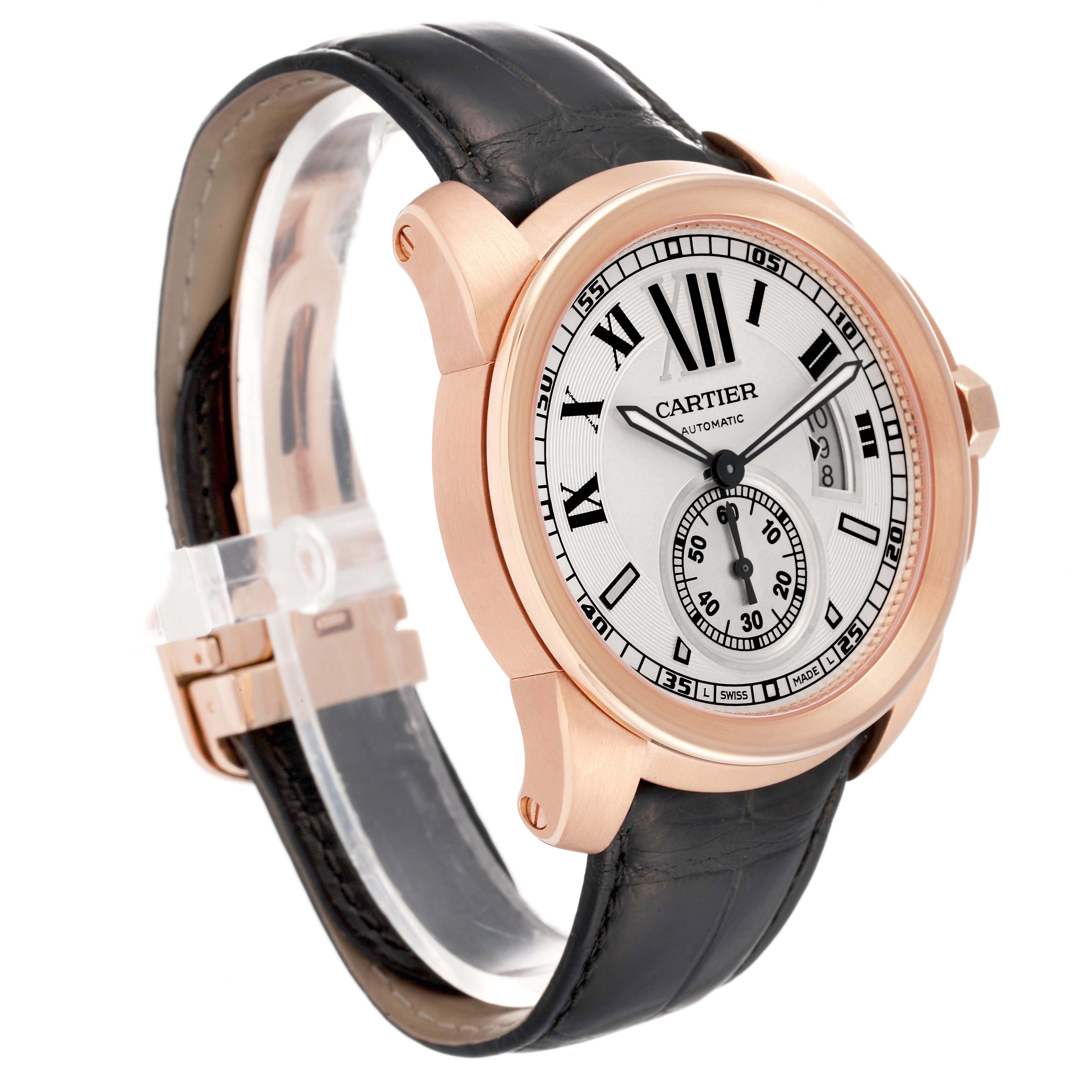 The Calibre de Cartier watch is shown at a three-quarter angle, displaying the dial, case, and leather strap.