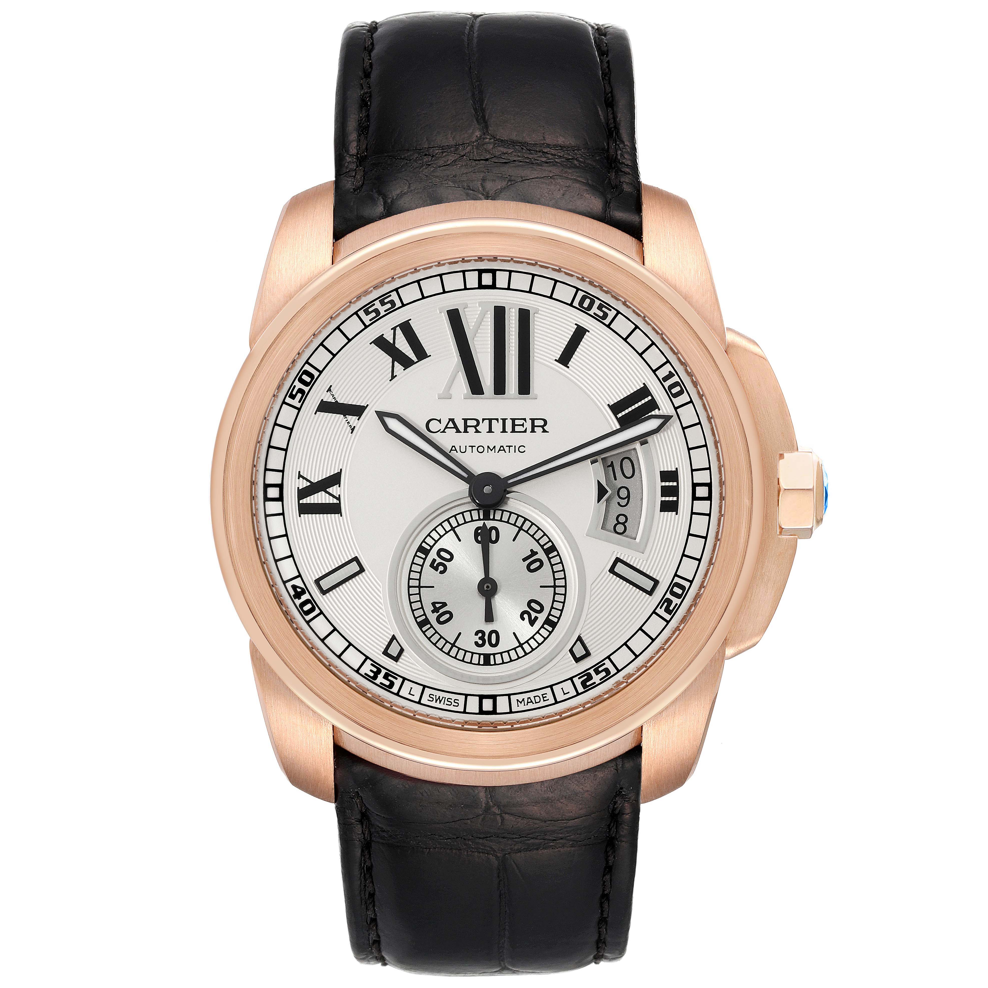 The Calibre de Cartier watch is shown from a front angle, displaying its dial, Roman numerals, date window, and leather strap.