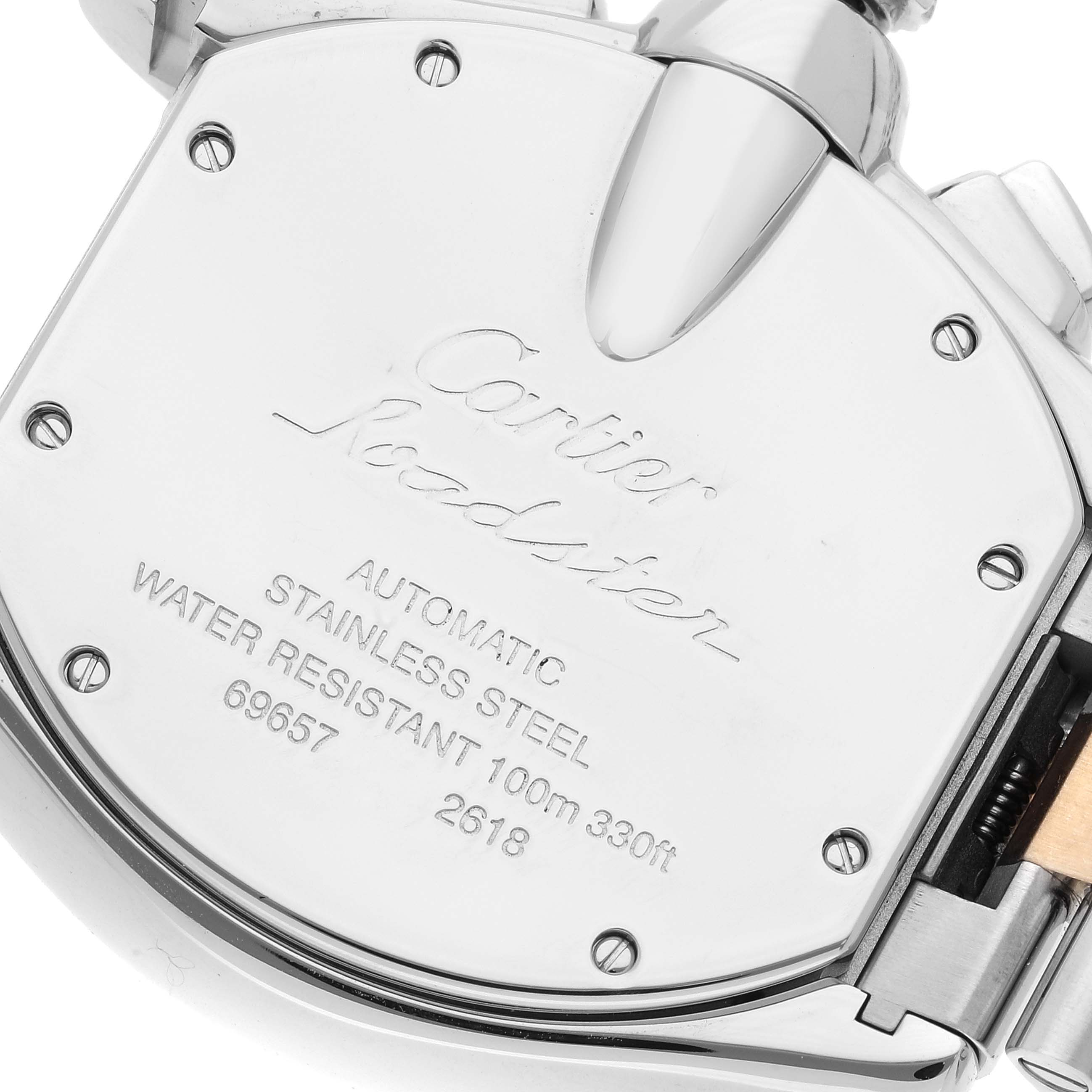 The image shows the back case of a Cartier Roadster W62027Z1 Men's Steel and Gold (two tone) Silver Dial W62027Z1 Men's Steel and Gold (two tone) Silver Dial watch, highlighting its inscriptions and screws.