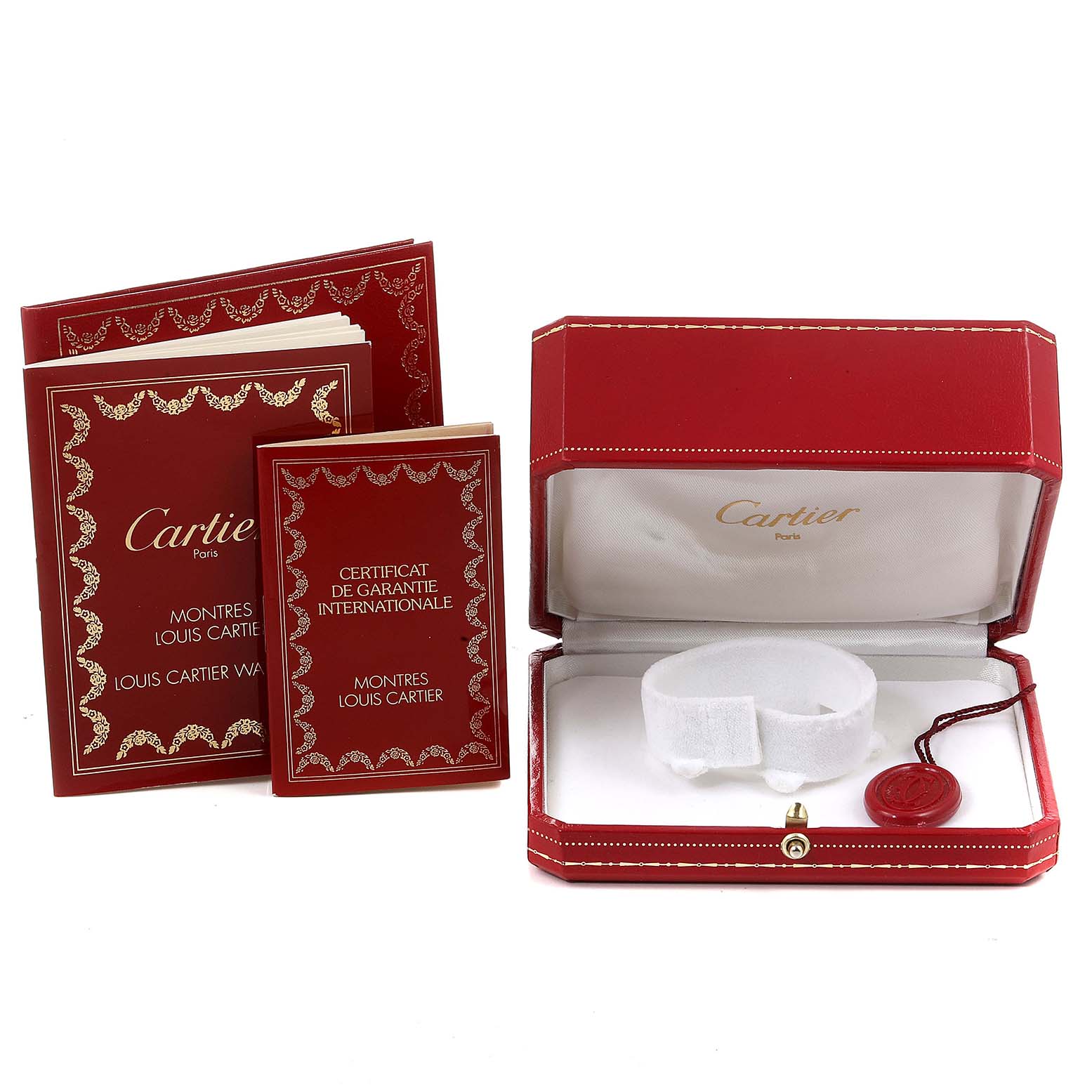 The image shows the packaging and documents of a Cartier Tank Américaine watch, including a red box and warranty booklets.