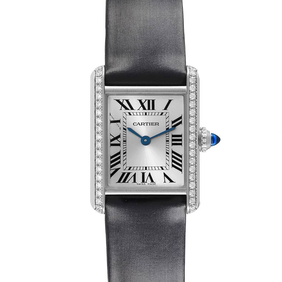 The Cartier Tank Must watch is shown front-on, highlighting its face, Roman numerals, and diamond-set case.