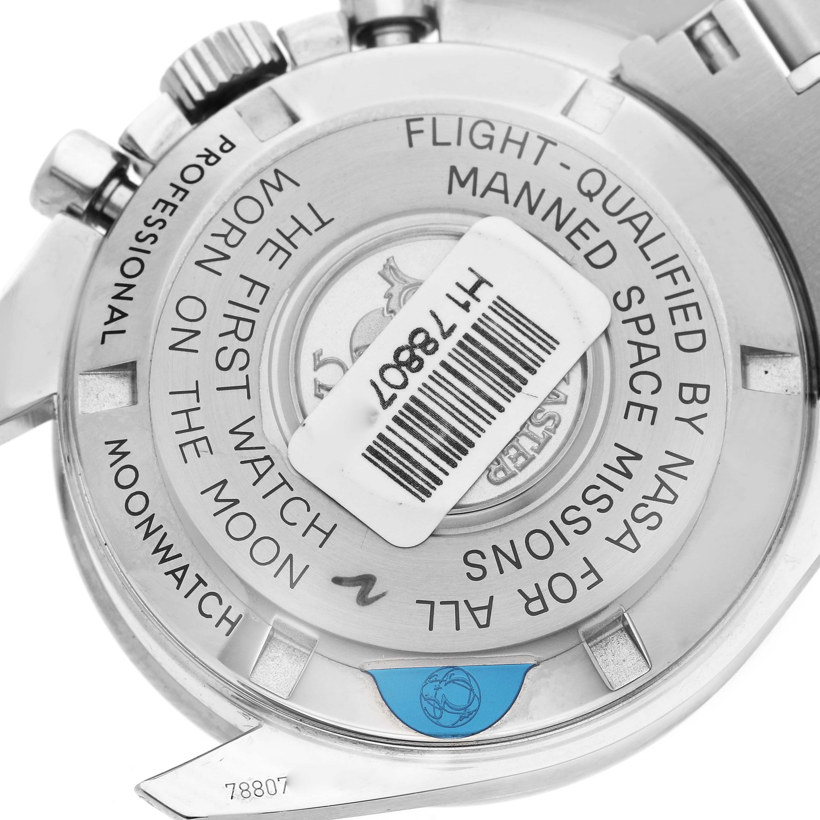 The image shows the back case of the Omega Speedmaster 311.30.42.30.01.005 Men's Stainless Steel Black Dial 311.30.42.30.01.005 Men's Stainless Steel Black Dial, highlighting its inscriptions and a barcode label.