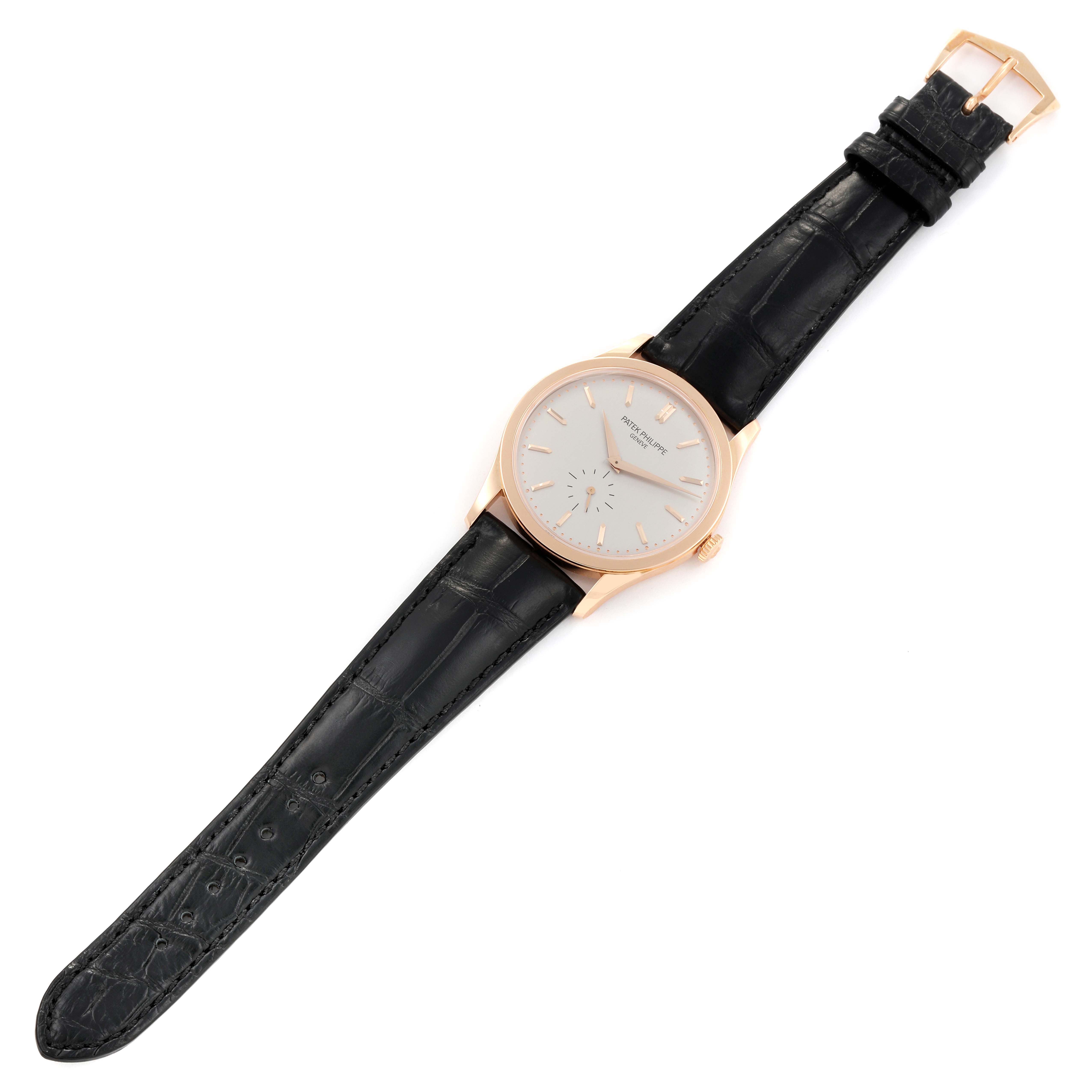This image shows a Patek Philippe Calatrava 5196R-001 Men's Rose Gold Silver Dial 5196R-001 Men's Rose Gold Silver Dial watch from a top-down angle, displaying the face, strap, and buckle.
