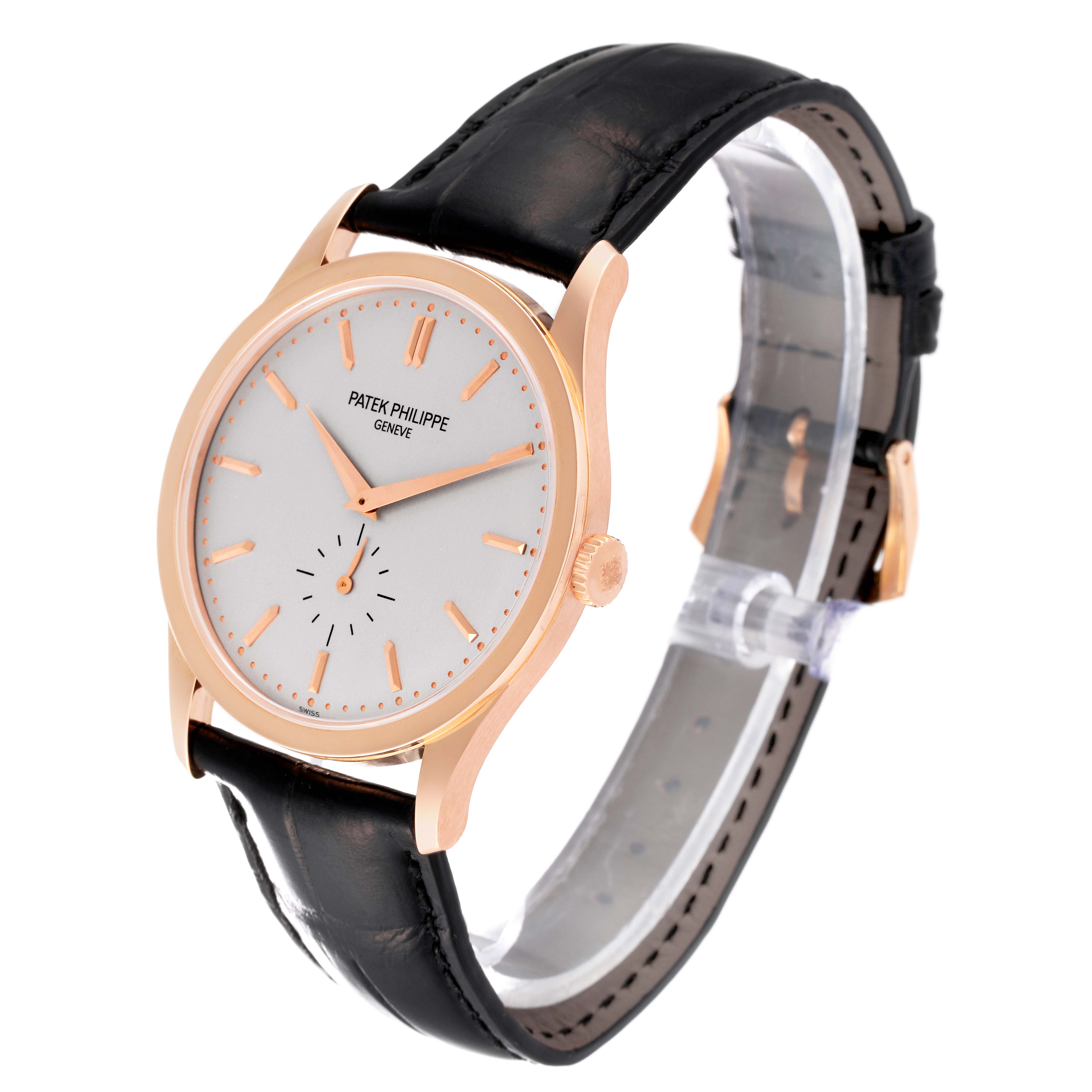 The image shows the Patek Philippe Calatrava 5196R-001 Men's Rose Gold Silver Dial 5196R-001 Men's Rose Gold Silver Dial watch at an oblique angle, featuring the face, crown, and leather strap.