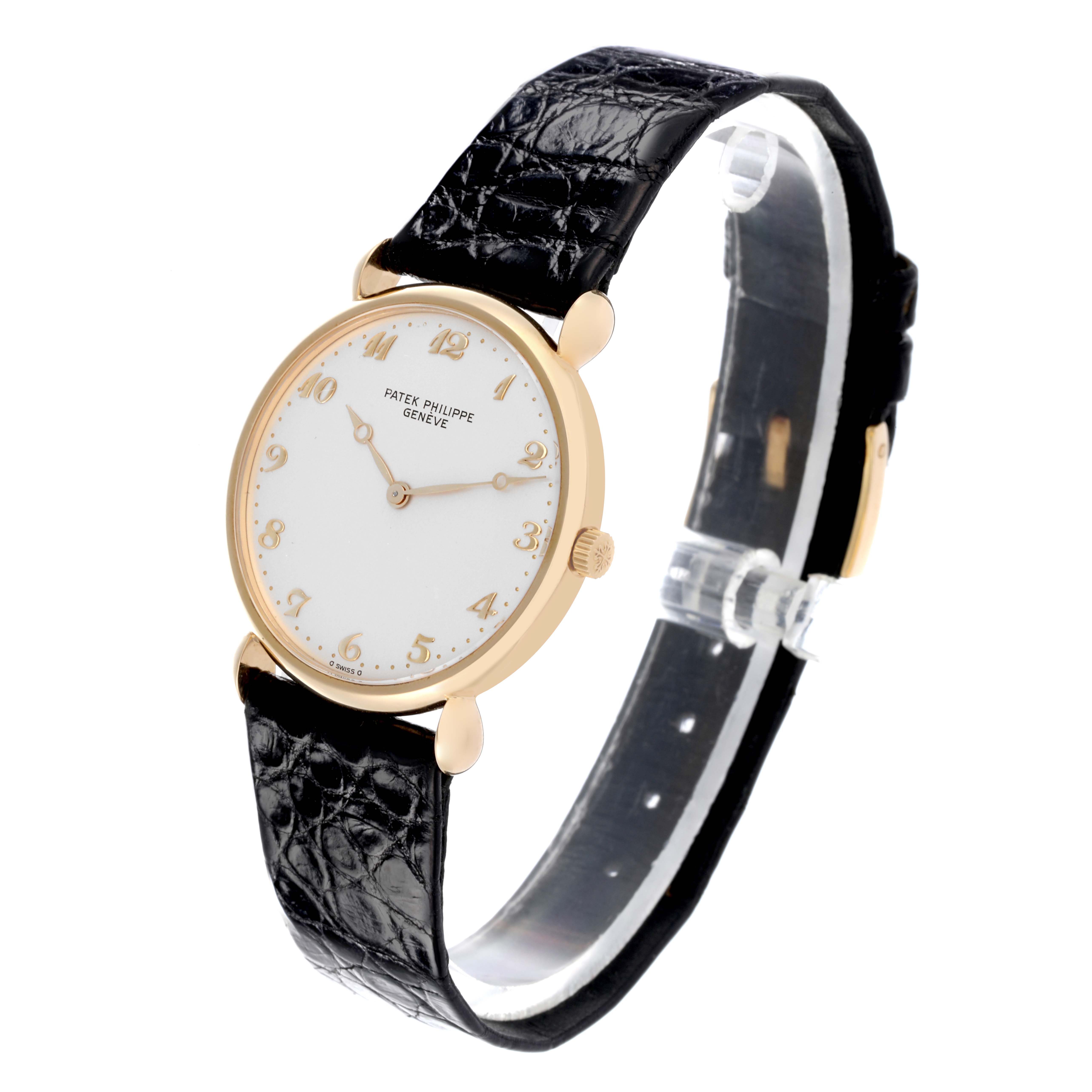 The Patek Philippe Calatrava Men's Yellow Gold Silver Dial Men's Yellow Gold Silver Dial watch is shown at a slight side angle, highlighting the face, bezel, and leather strap.