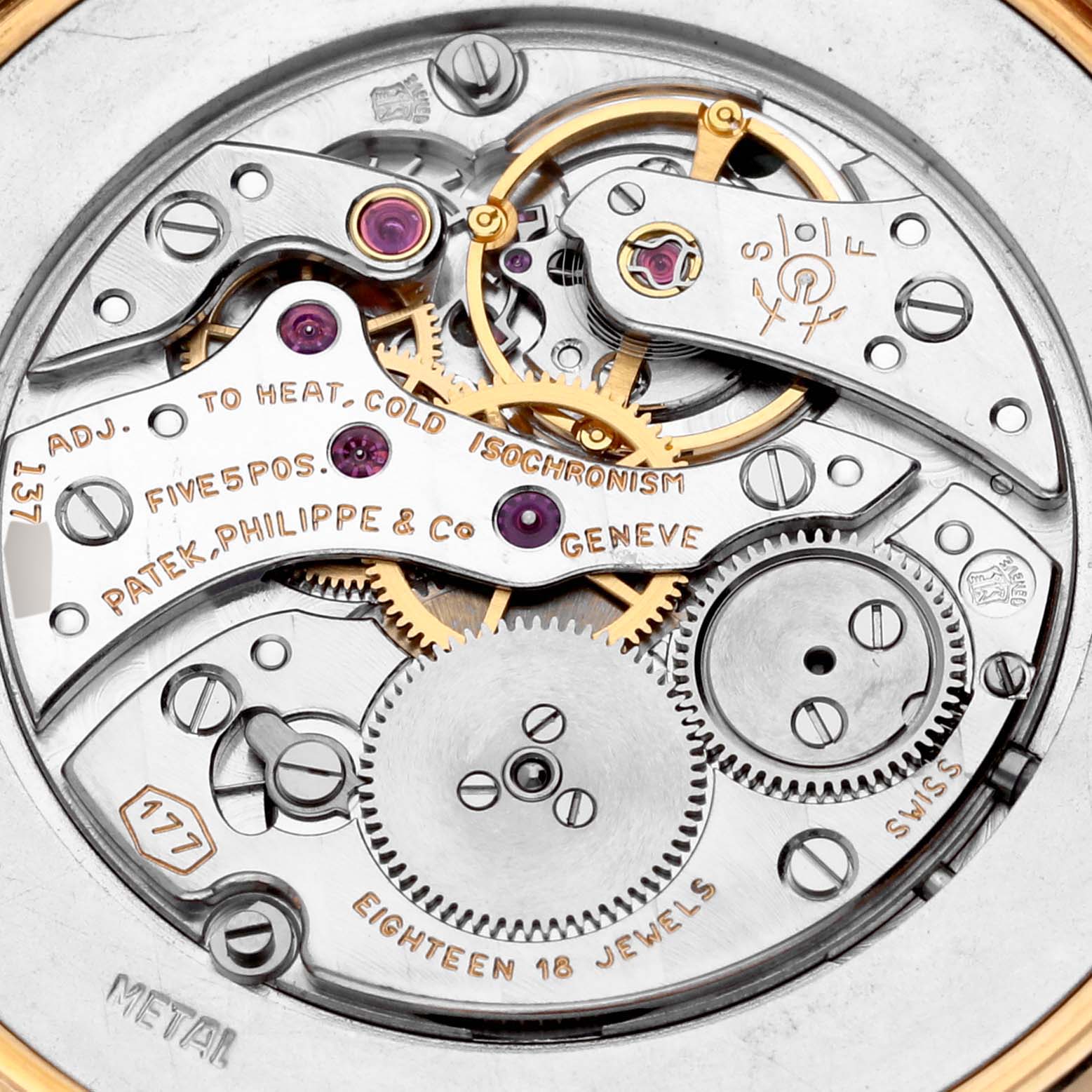 The image shows the intricate movement and mechanism of a Patek Philippe Calatrava Men's Yellow Gold Silver Dial Men's Yellow Gold Silver Dial watch from a top-down angle.