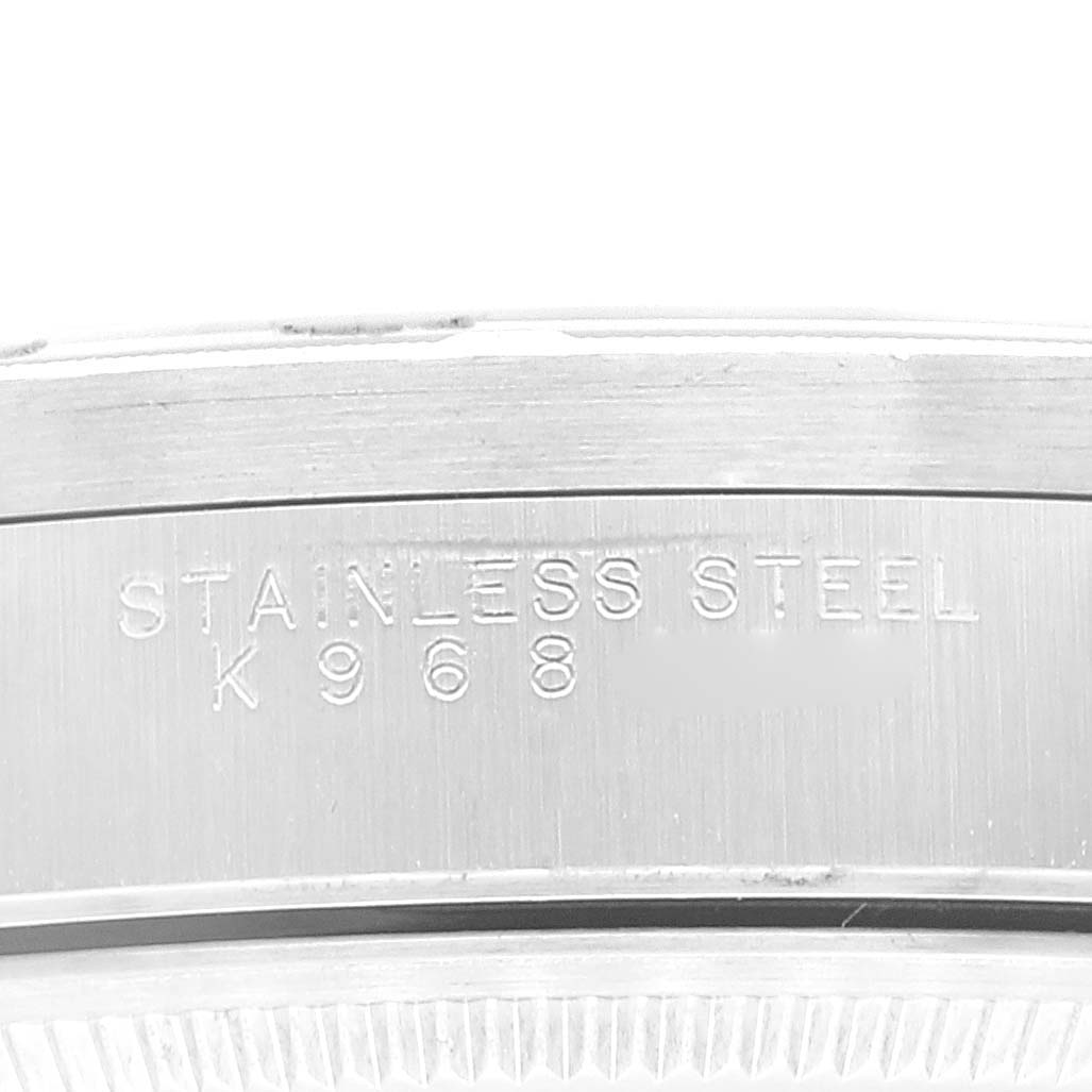 This image shows a close-up of the stainless steel case of a Rolex Air-King 14010 Men's Stainless Steel Black Dial 14010 Men's Stainless Steel Black Dial watch, displaying the engraving "STAINLESS STEEL K 968."