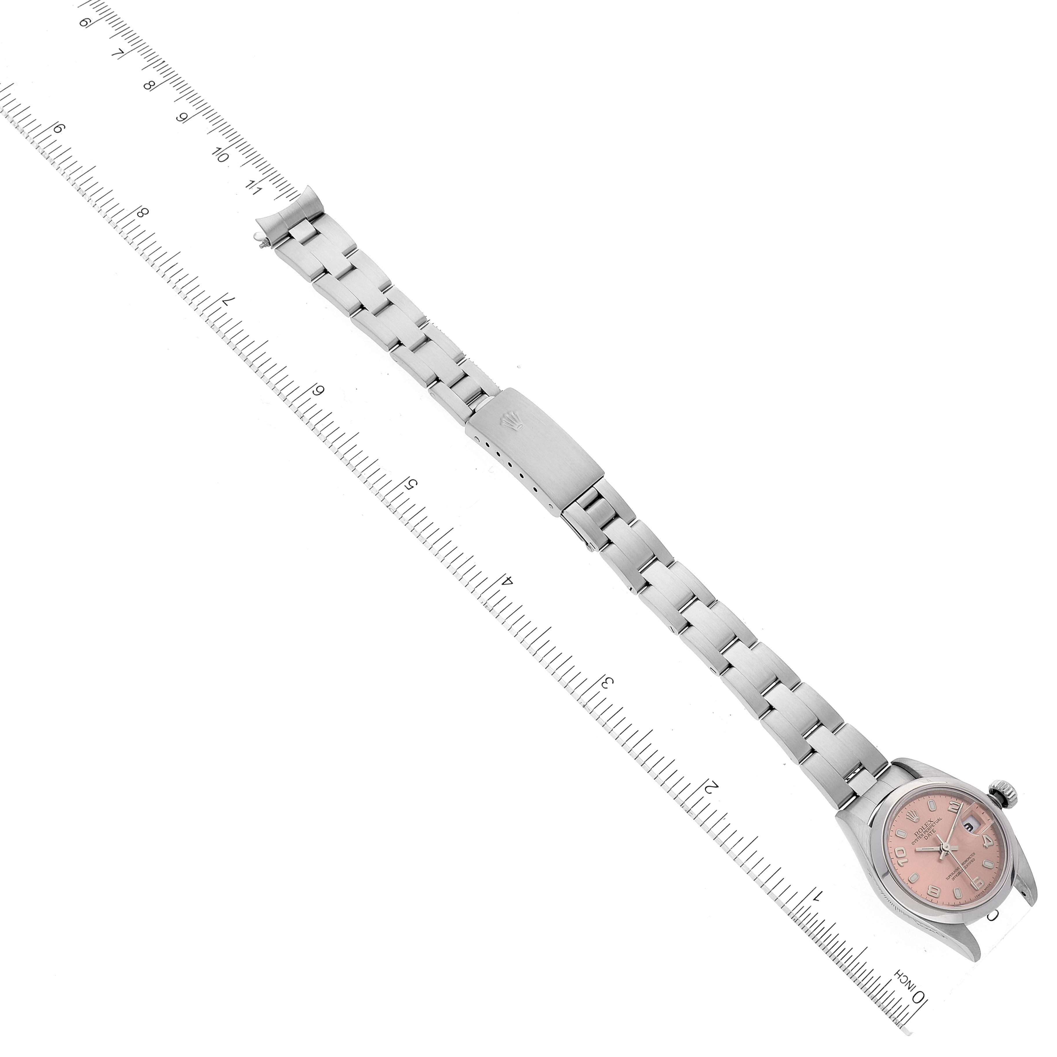 This image shows a top-down view of a Rolex Date 79160 Women's Stainless Steel White Dial 79160 Women's Stainless Steel White Dial watch, including the full bracelet and the watch face, with a ruler for scale.