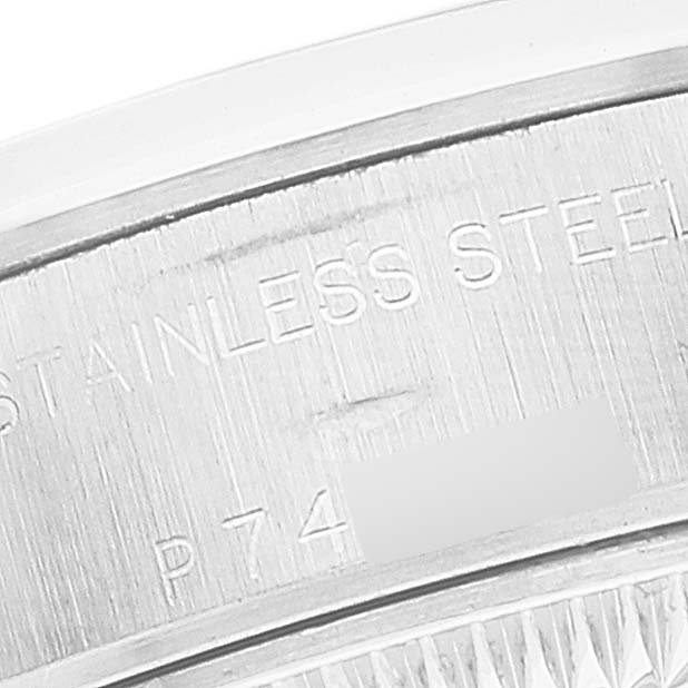 This is a close-up of the stainless steel case back edge of a Rolex Date 79160 Women's Stainless Steel White Dial 79160 Women's Stainless Steel White Dial model watch, showing part of its engraving detail.