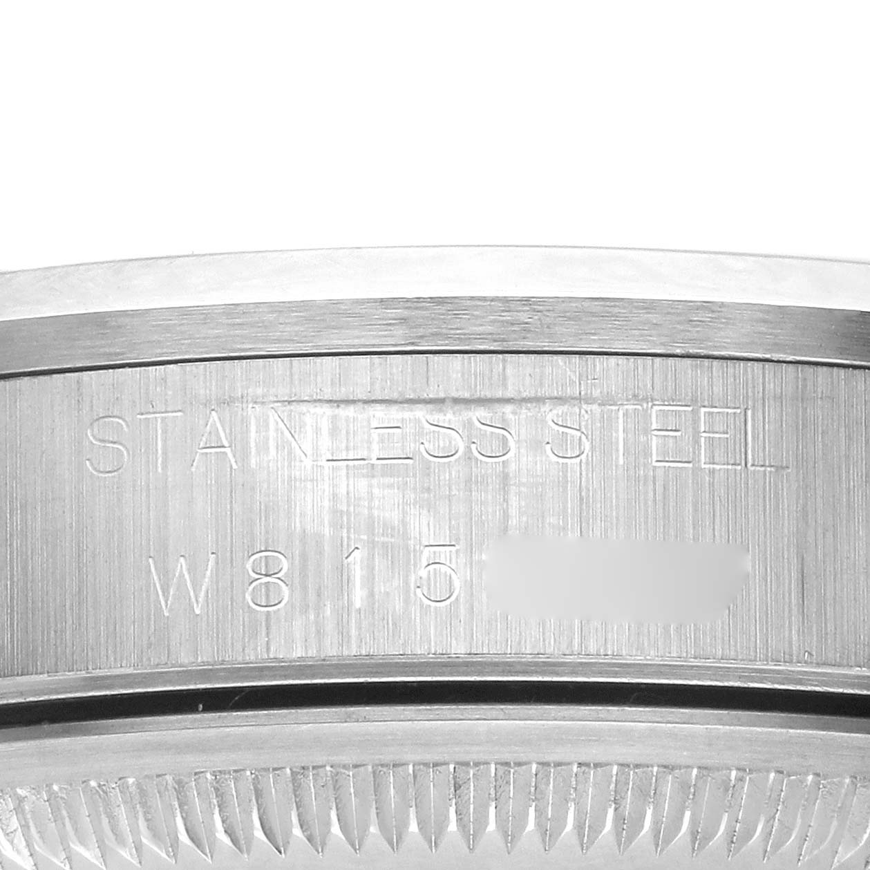 The image shows the side engraving on the bezel of a Rolex Air-King, highlighting "STAINLESS STEEL."