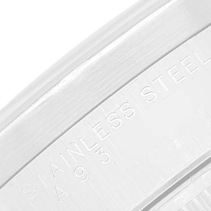 The image shows a close-up angle of the case back rim detailing "STAINLESS STEEL" on a Rolex Air-King watch.