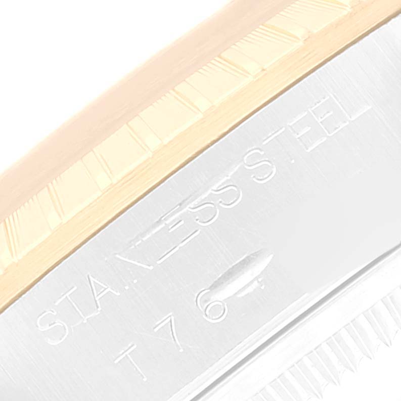 This close-up image shows the edge and engravings on the stainless steel part of a Rolex Date 15223 Men
s Steel and Gold (two tone) Champagne Dial 15223 Men
s Steel and Gold (two tone) Champagne Dial model.