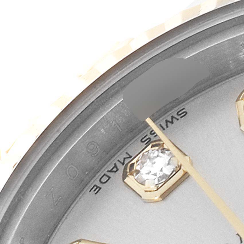 The image shows a close-up angle of the dial and bezel of a Rolex Datejust 179173 Women's Steel and Gold (two tone) Silver Dial 179173 Women's Steel and Gold (two tone) Silver Dial, highlighting the "SWISS MADE" text and a diamond hour marker.