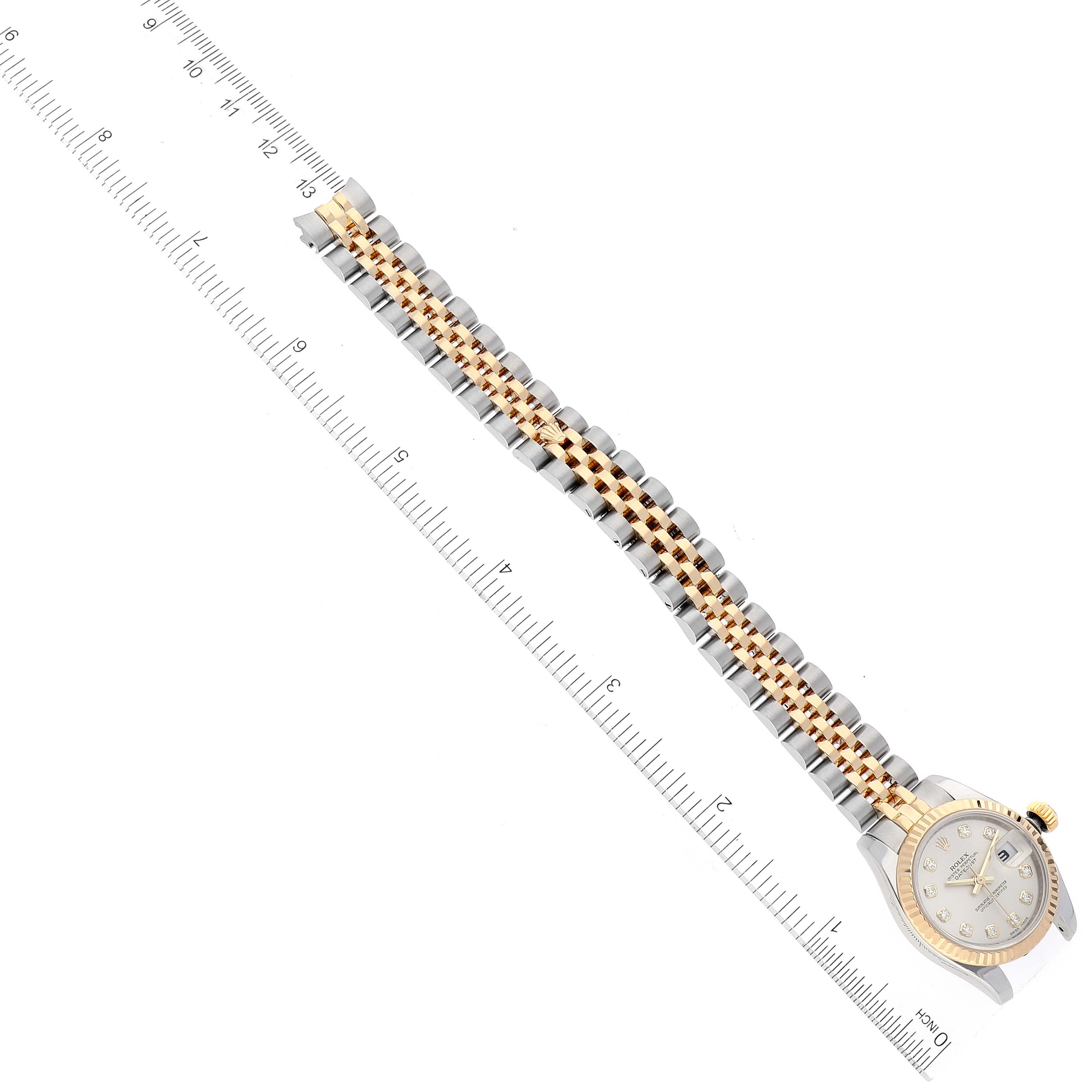 The image shows a Rolex Datejust 179173 Women's Steel and Gold (two tone) Silver Dial 179173 Women's Steel and Gold (two tone) Silver Dial watch from a top-down angle, featuring part of its gold and silver bracelet and watch face.