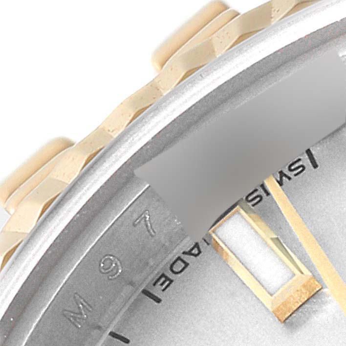This close-up image of a Rolex Datejust 179173 Women's Steel and Gold (two tone) Silver Dial 179173 Women's Steel and Gold (two tone) Silver Dial watch shows the dial, part of the bezel, and the bracelet links.