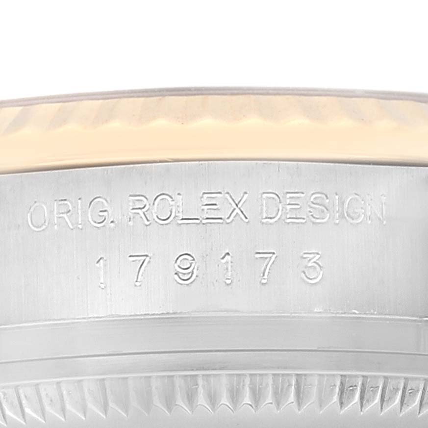 The image shows an up-close view of the serial number engraving on the side of the Rolex Datejust 179173 Women's Steel and Gold (two tone) Champagne Dial 179173 Women's Steel and Gold (two tone) Champagne Dial watch case.