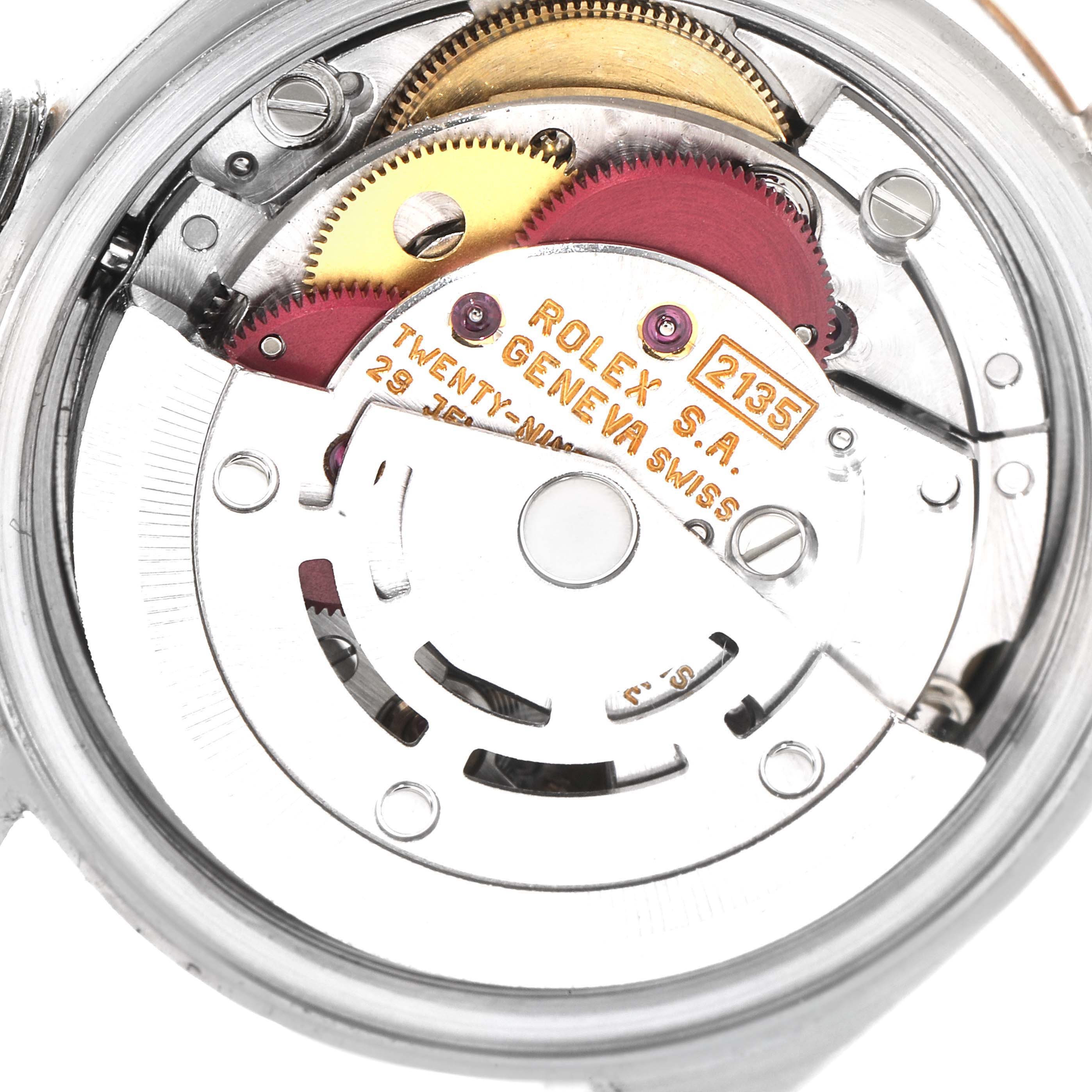 This is a close-up view of the Rolex Datejust 69173 Women's Steel and Gold (two tone) Champagne Dial 69173 Women's Steel and Gold (two tone) Champagne Dial watch movement, showing gears and inscriptions.