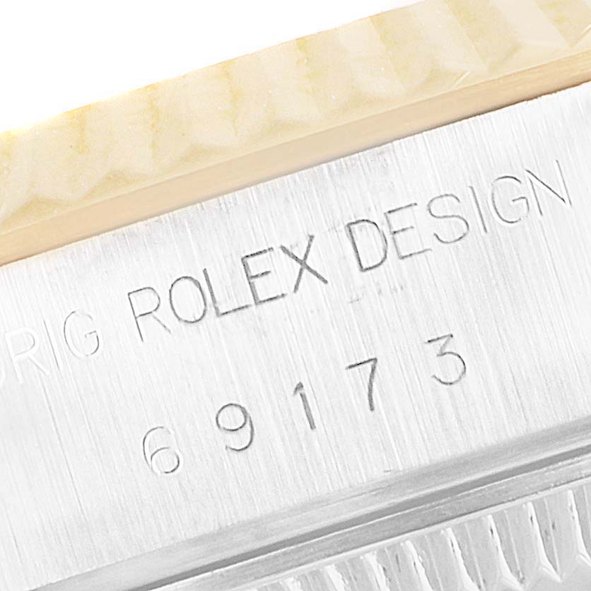 The image shows a close-up view of the engraved model number and text "ROLEX DESIGN" on a Rolex Datejust 69173 Women's Steel and Gold (two tone) Champagne Dial 69173 Women's Steel and Gold (two tone) Champagne Dial watch.
