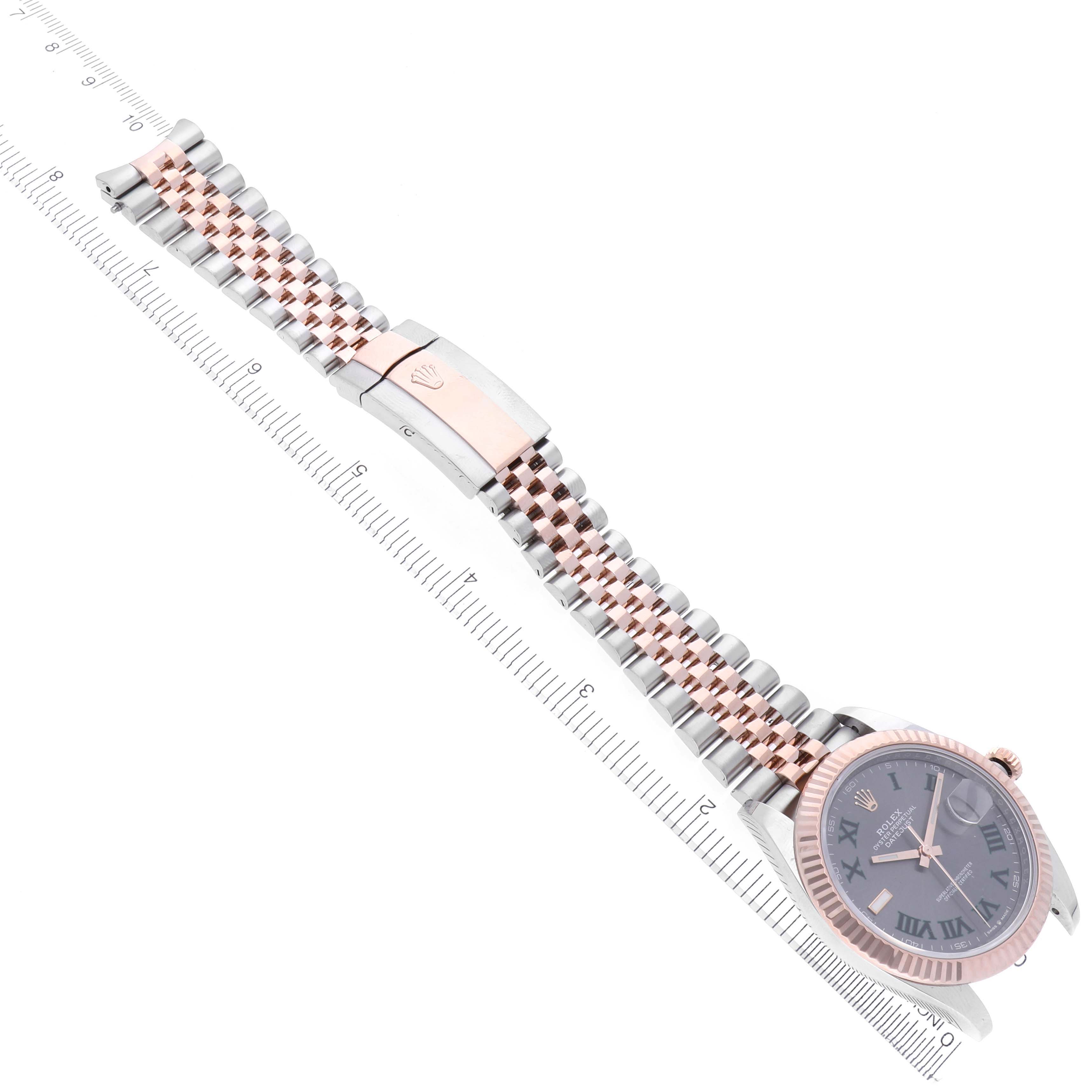 The Rolex Datejust 41 126331 Men's Steel and Gold (two tone) Grey Dial 126331 Men's Steel and Gold (two tone) Grey Dial is shown from a top angle with its full bracelet and clasp, alongside a measuring ruler.