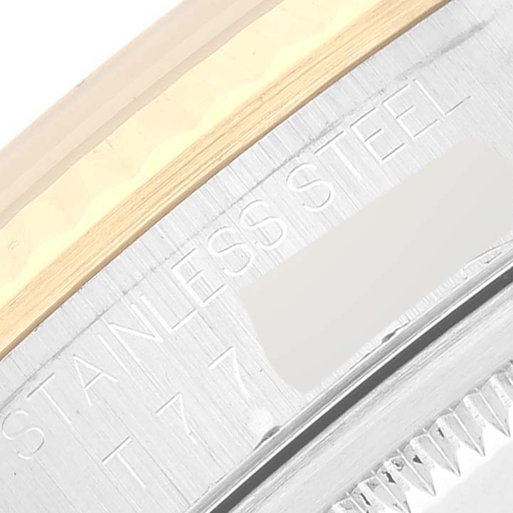This close-up image shows the side engraving on the case back of a Rolex Datejust 16233 Men's Steel and Gold (two tone) Grey Dial 16233 Men's Steel and Gold (two tone) Grey Dial watch, indicating it is made of stainless steel.