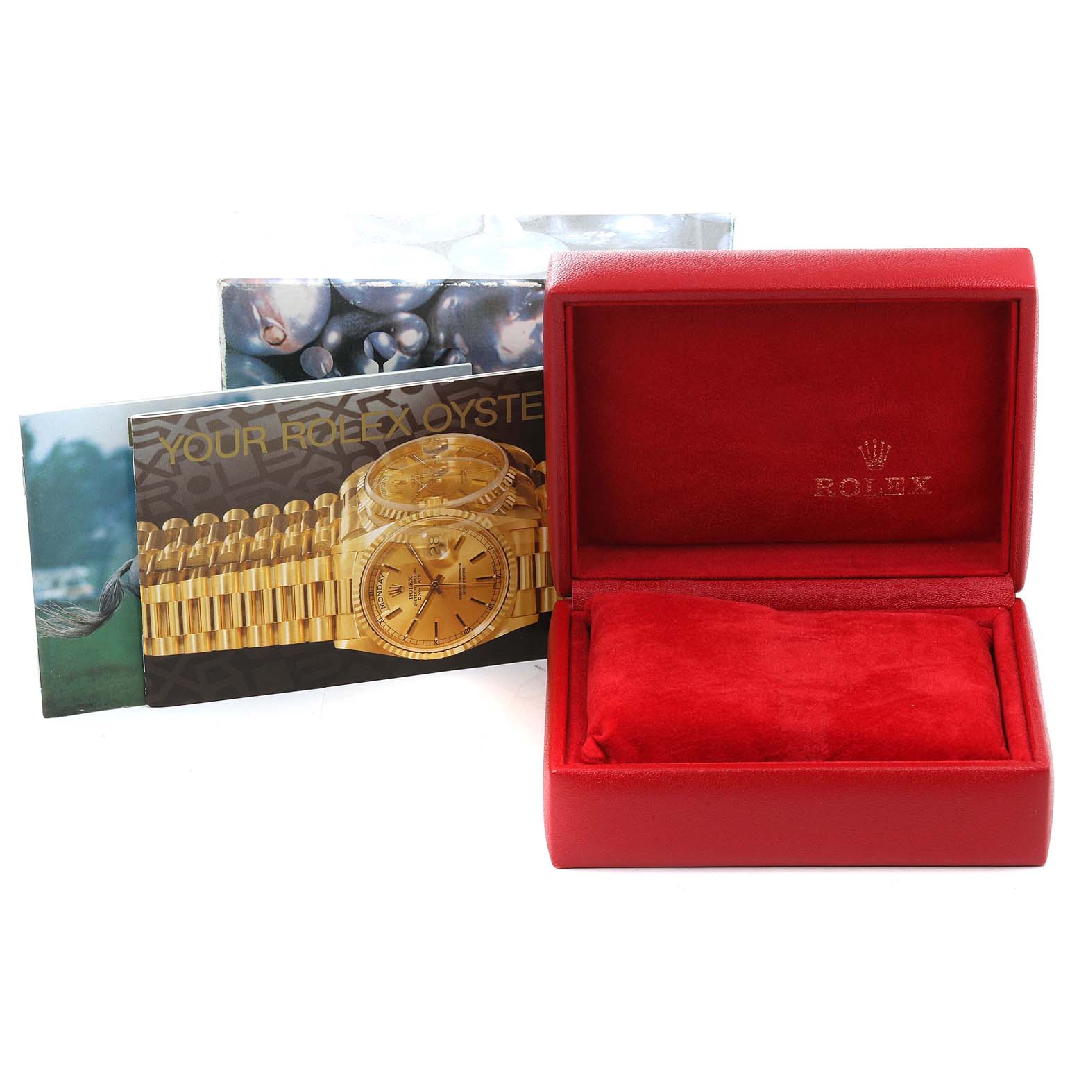The image shows an open red Rolex box, Datejust model brochures, and accessories but no watch.