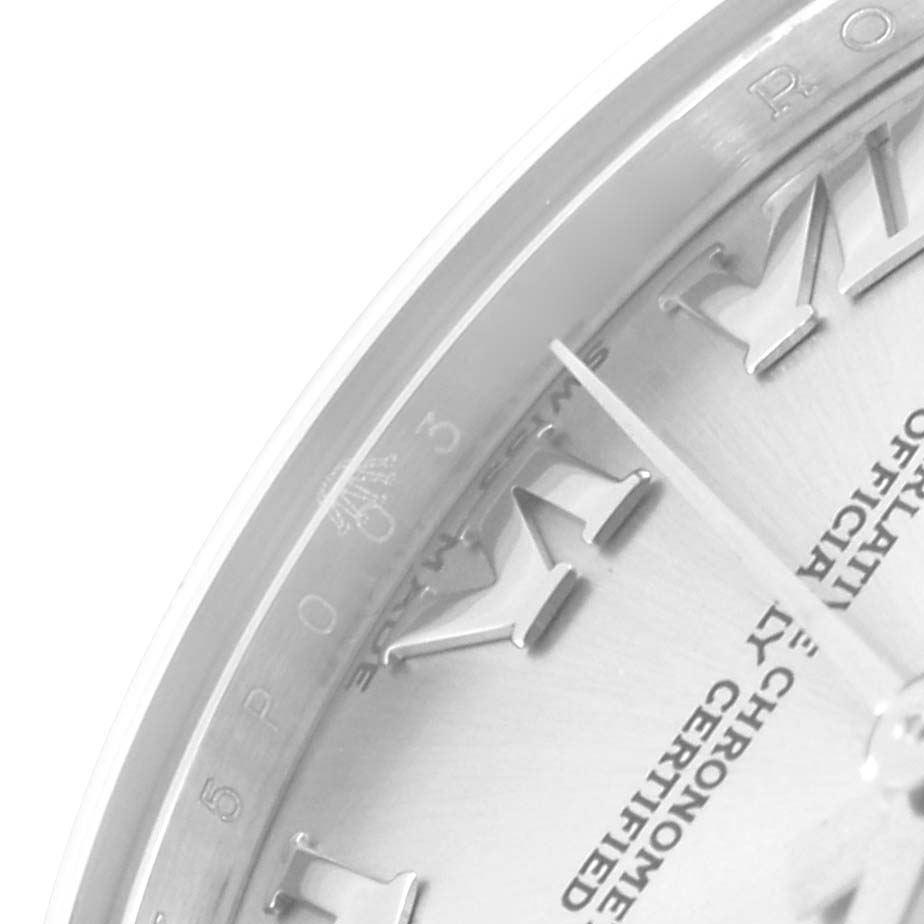 Close-up of the Rolex Mid-Size 178274 Women
s Stainless Steel Silver Dial 178274 Women
s Stainless Steel Silver Dial watch showing the upper left part of the dial with Roman numerals and partial text.