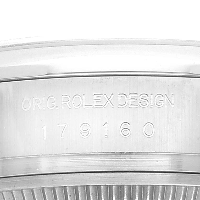 This close-up image shows the case side of a Rolex Datejust 179160 Women's Stainless Steel Silver Dial 179160 Women's Stainless Steel Silver Dial watch, displaying its serial and model number.