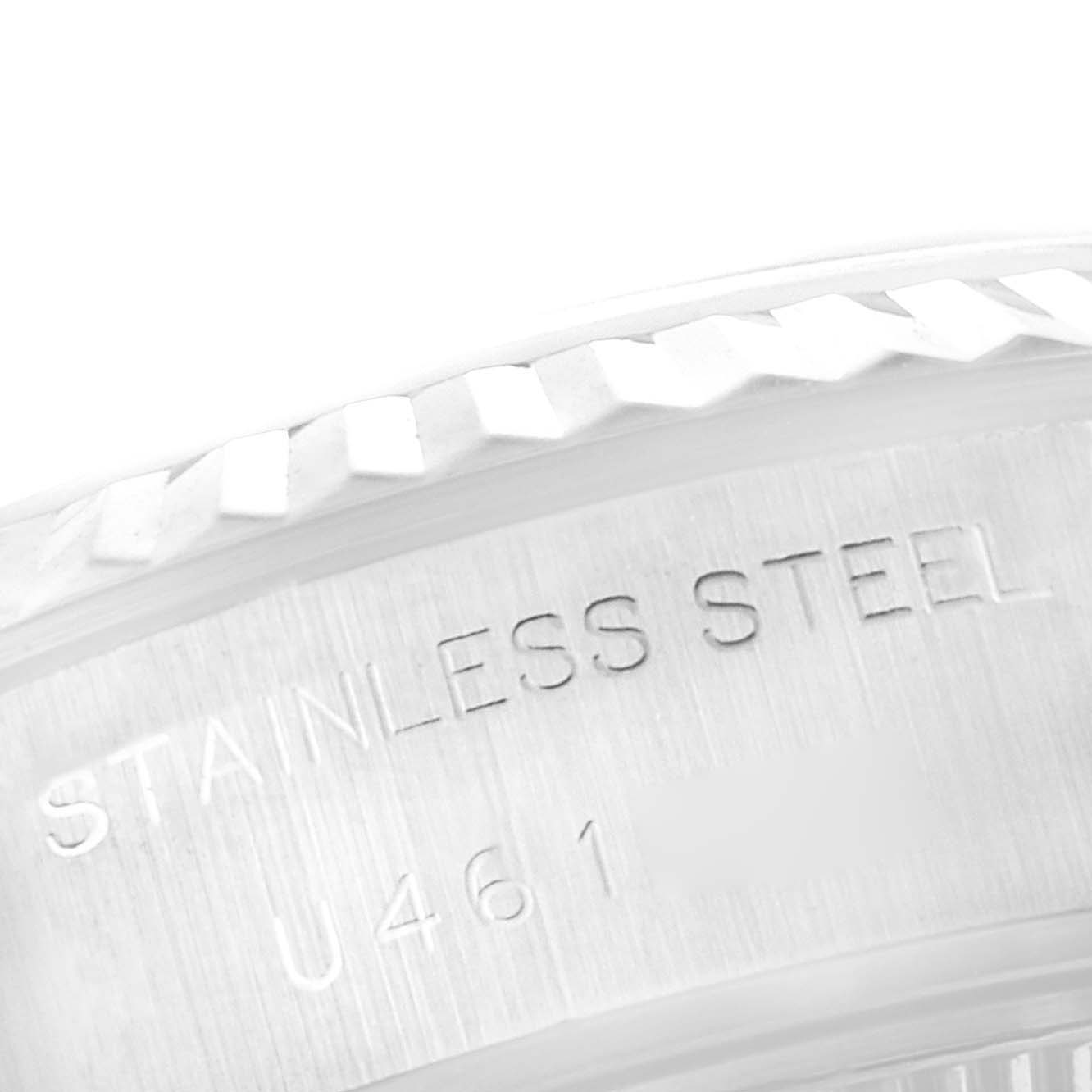 This close-up shows part of the bezel and the text on the case side of a Rolex Datejust 69174 Women's Stainless Steel Black Dial 69174 Women's Stainless Steel Black Dial watch.