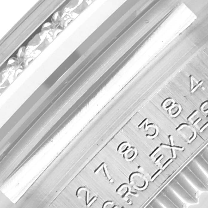 The image shows a close-up angle of the Rolex Mid-Size 278384 Women's Stainless Steel Blue Dial 278384 Women's Stainless Steel Blue Dial model's engraved inner bezel.