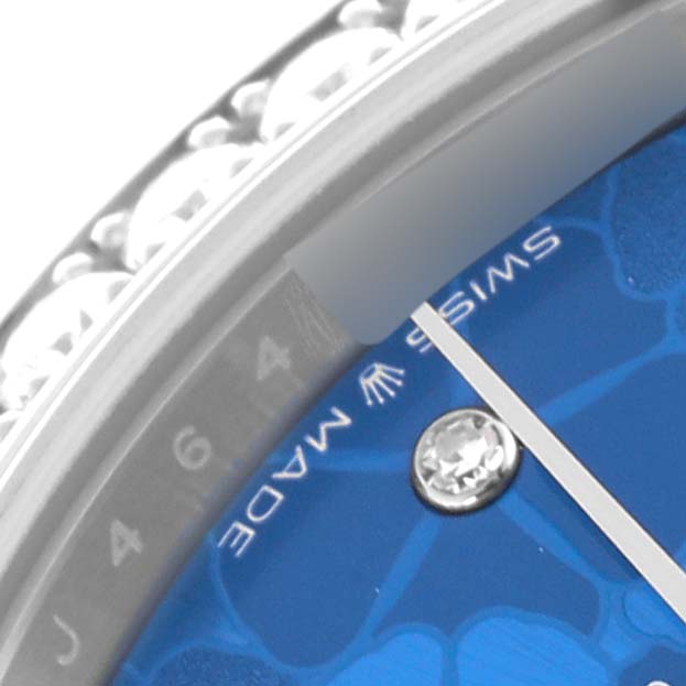 The image shows a close-up of the dial and part of the bezel of a Rolex Mid-Size 278384 Women's Stainless Steel Blue Dial 278384 Women's Stainless Steel Blue Dial watch, highlighting the hour markers.