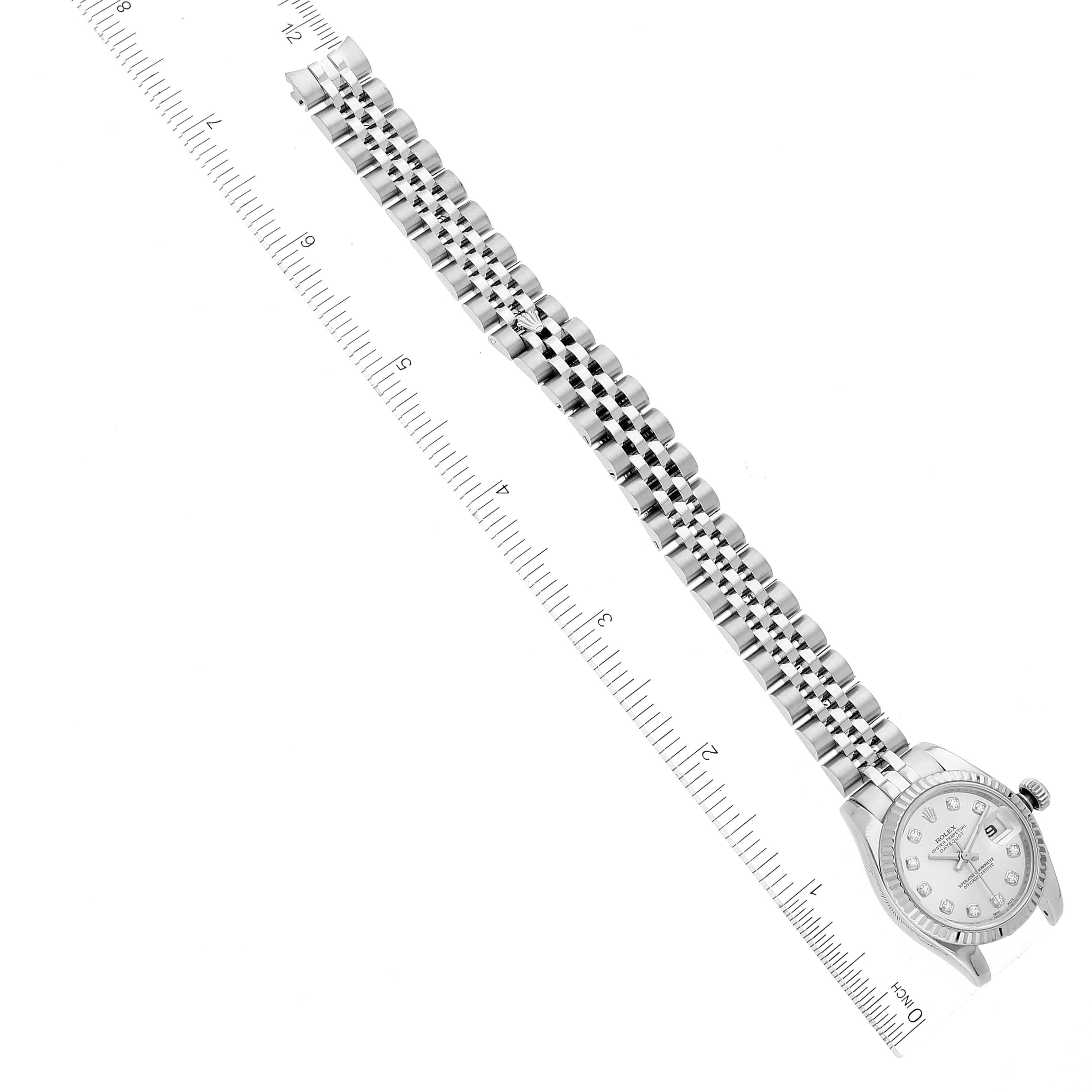 The image shows a Rolex Datejust 179174 Women's Stainless Steel Silver Dial 179174 Women's Stainless Steel Silver Dial watch laid flat with a focus on the face and full bracelet, positioned alongside a ruler.