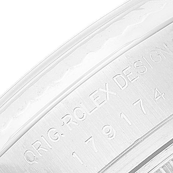 This close-up image shows the engraving on the inner bezel of a Rolex Datejust 179174 Women's Stainless Steel Silver Dial 179174 Women's Stainless Steel Silver Dial watch.