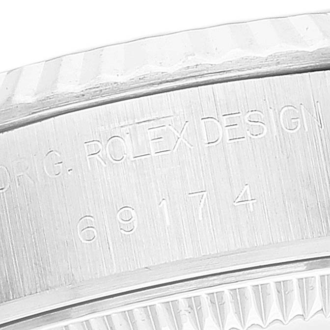 The image shows a close-up of the Rolex Datejust 69174 Women's Stainless Steel Silver Dial 69174 Women's Stainless Steel Silver Dial watch's case back engraving.