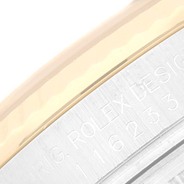 The image shows a close-up of the bezel and engraved text on the casing of a Rolex Datejust 116233 Men's Steel and Gold (two tone) Black Dial 116233 Men's Steel and Gold (two tone) Black Dial watch.