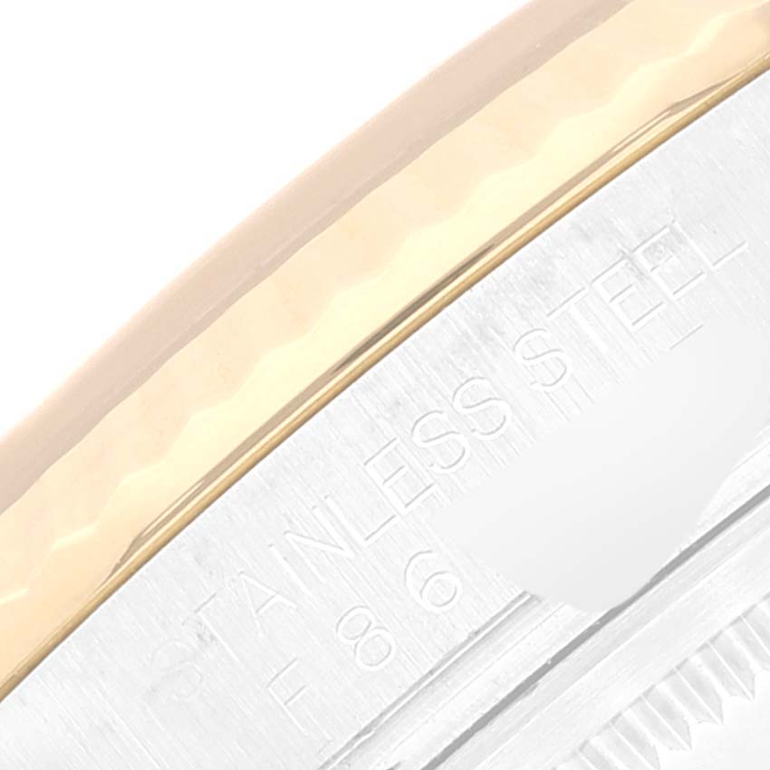 The image shows a close-up of the stainless steel and gold bezel on a Rolex Datejust 116233 Men's Steel and Gold (two tone) Black Dial 116233 Men's Steel and Gold (two tone) Black Dial watch.